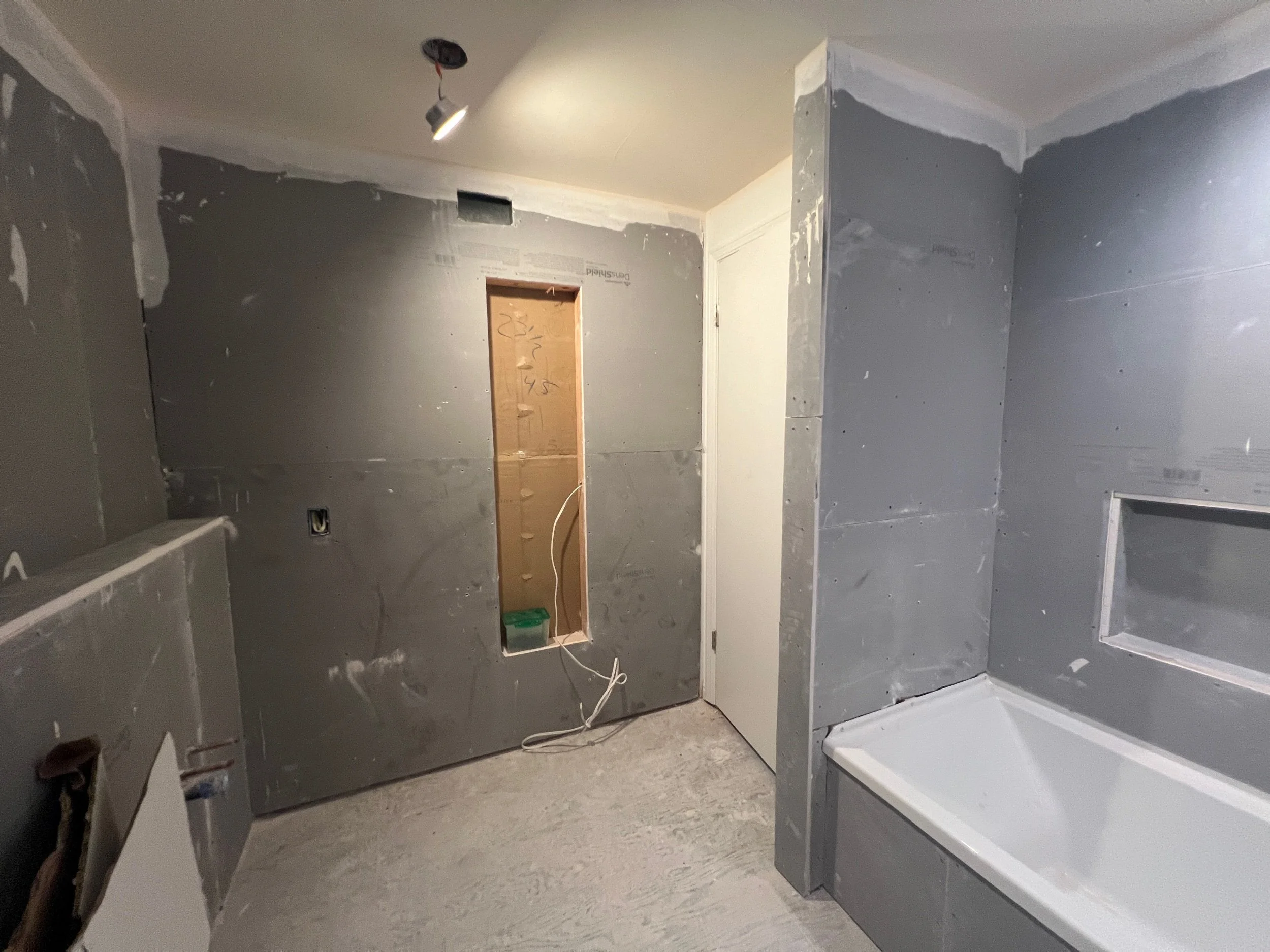 Given our wall to wall tile design, all the walls have been prepped with a gray Dens Shield Tile Backer. The gray is a built-in fiberglass mat with an acrylic coating, which acts as a moisture barrier.
