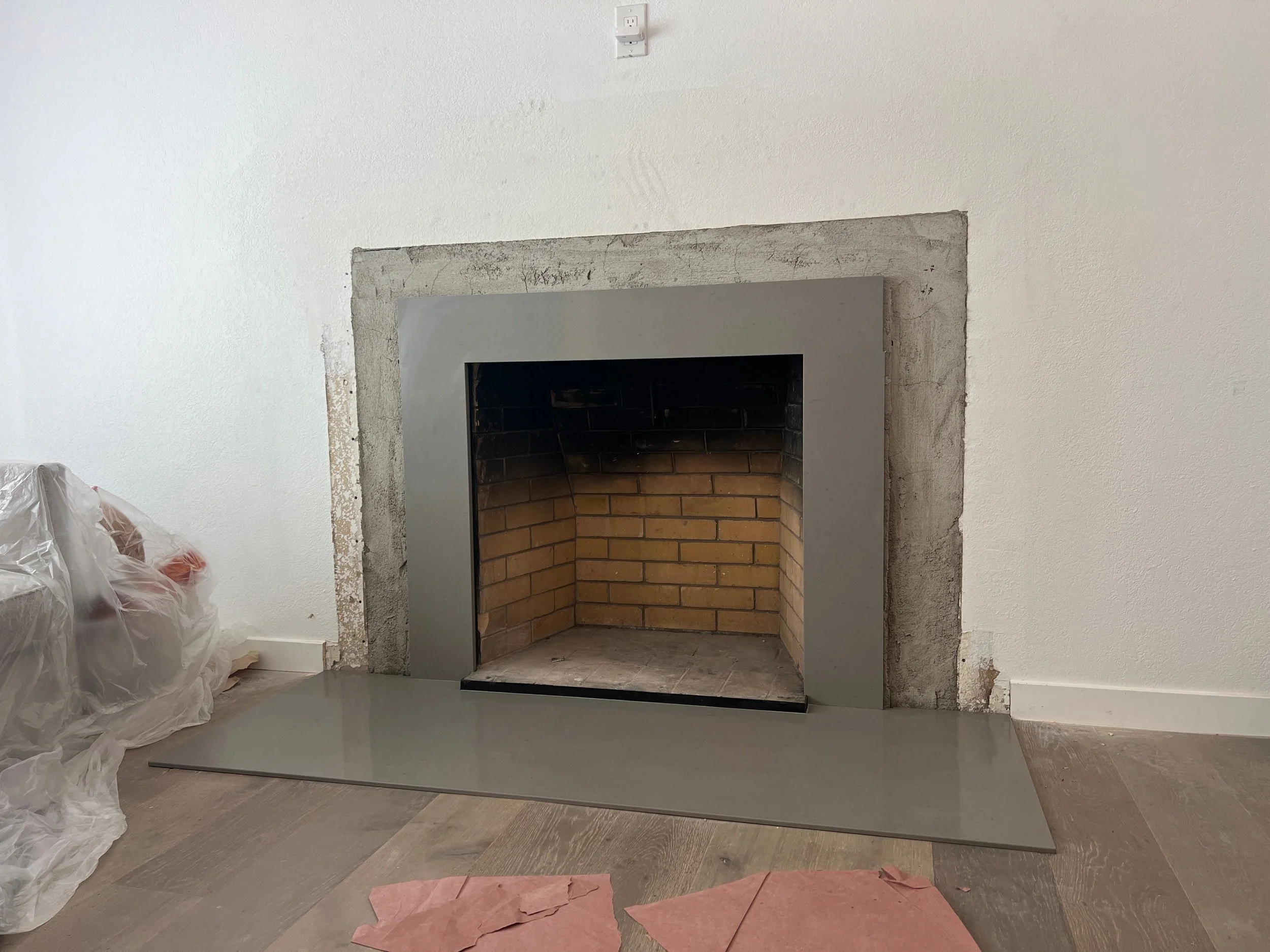 Our flush new hearth continues up to become our surround - with our new limestone mantel coming next as the pièce de résistance!