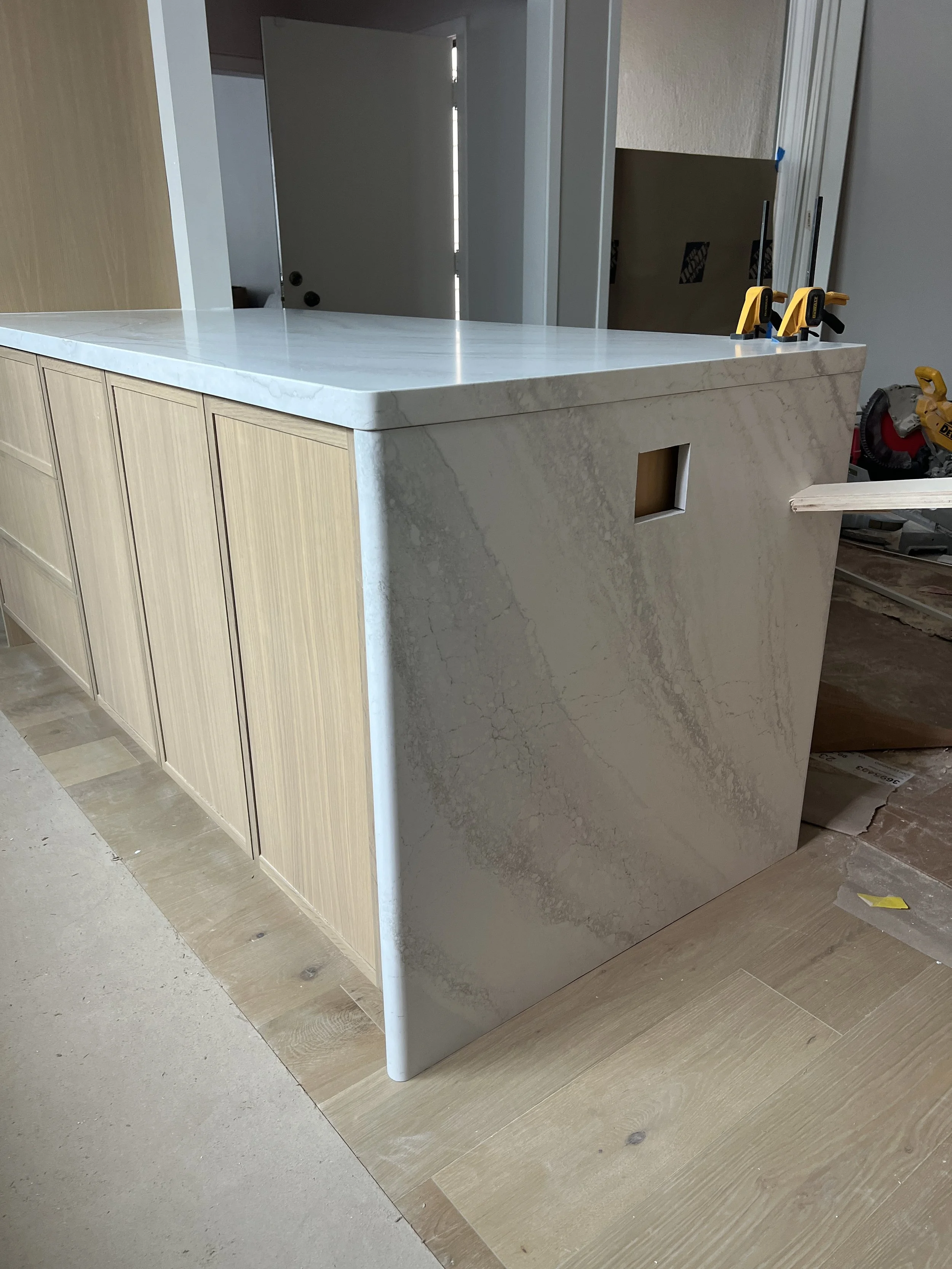 Round edge countertop with radiused waterfall detail.