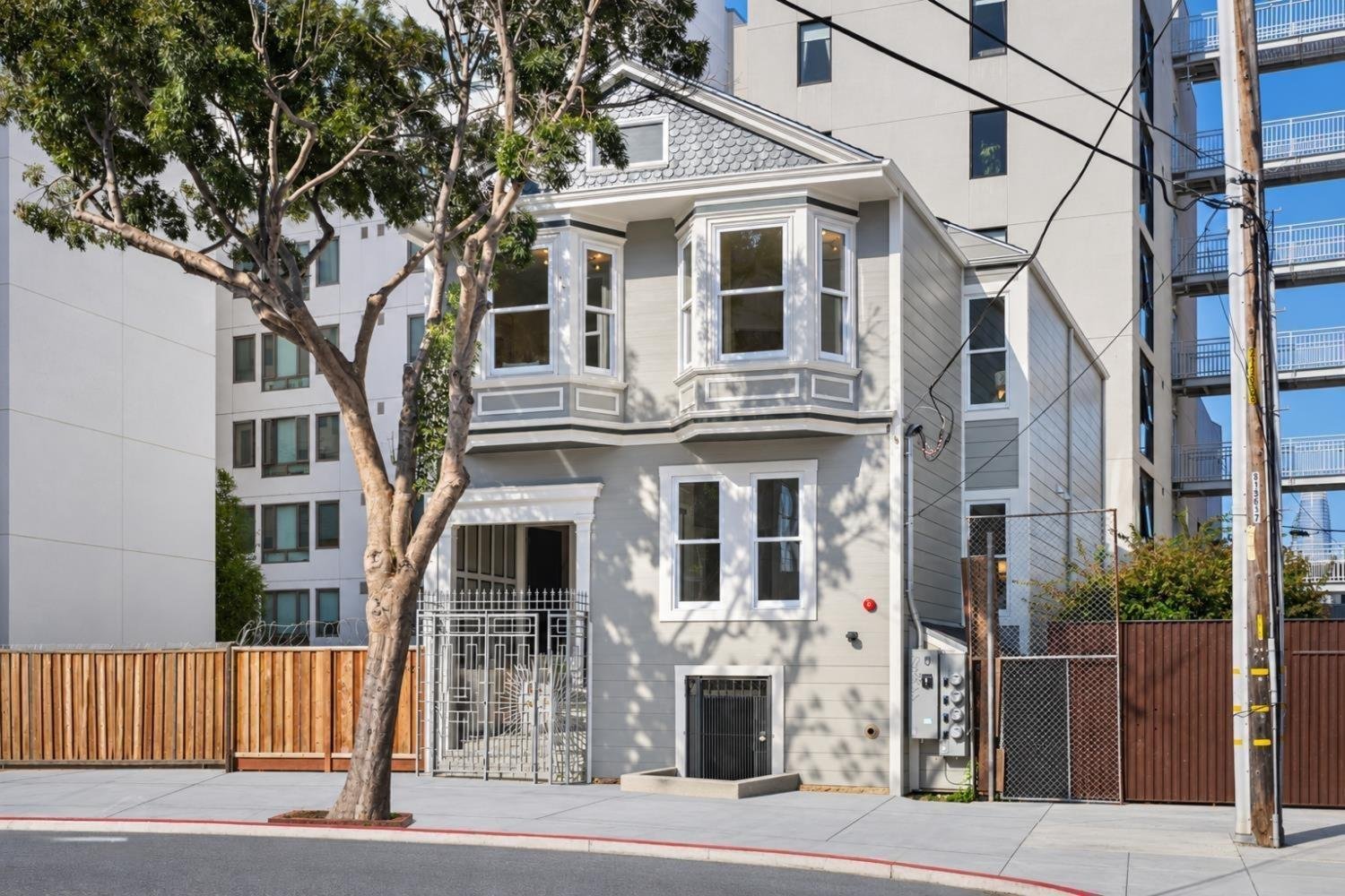  Surrounded on the left by an eight-story apartment complex with 200 rental units, and to the right and rear by three seven-story buildings totaling 136 rental units, our modest two-story historic house—built in 1907—stands out like the real-life ver