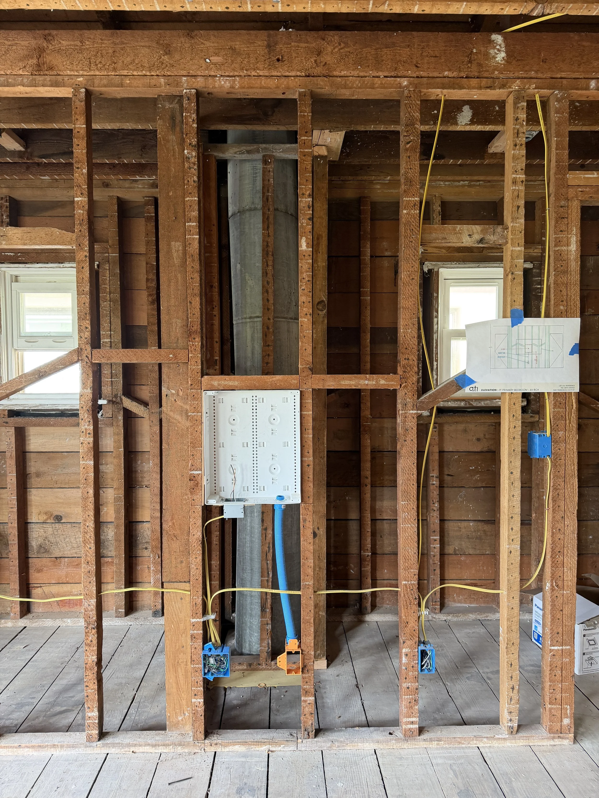 Wall mounted TVs require careful wire management.  Here the blue "Smurf" tube will serve as a conduit to conceal wires (e.g. HDMI) running to the back of the TV.