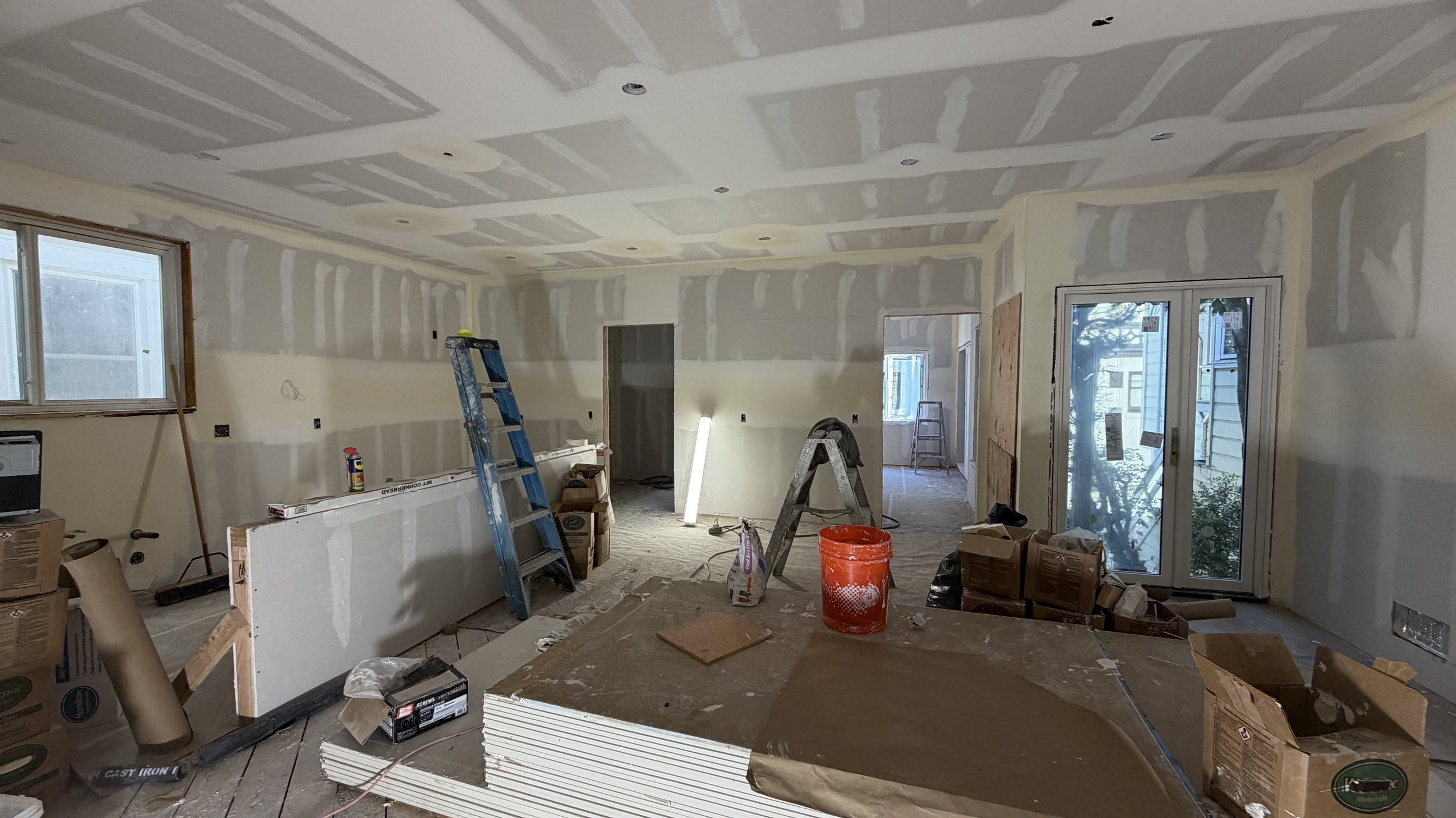 With drywall inspections behind us, taping, mudding, & sanding work are well underway...