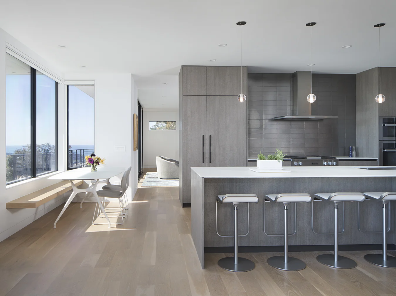 The kitchen is lit by bright windows.