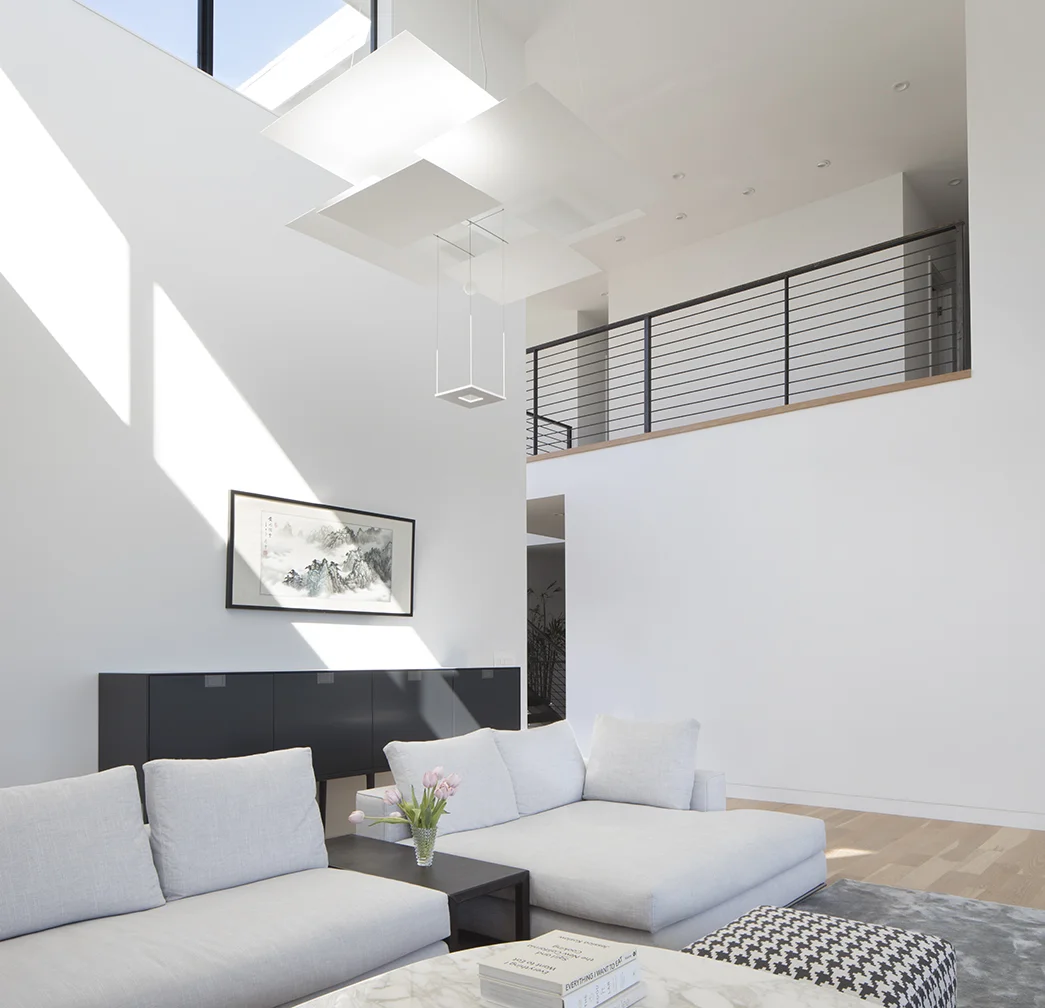 The white walls and windows make the living room feel expansive.