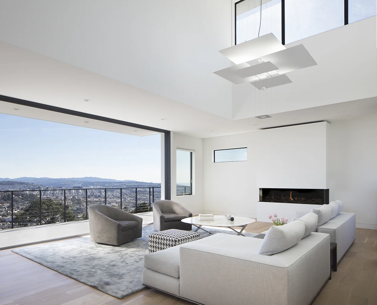 The living room balcony is beyond a large door that opens up a whole wall to the exterior.
