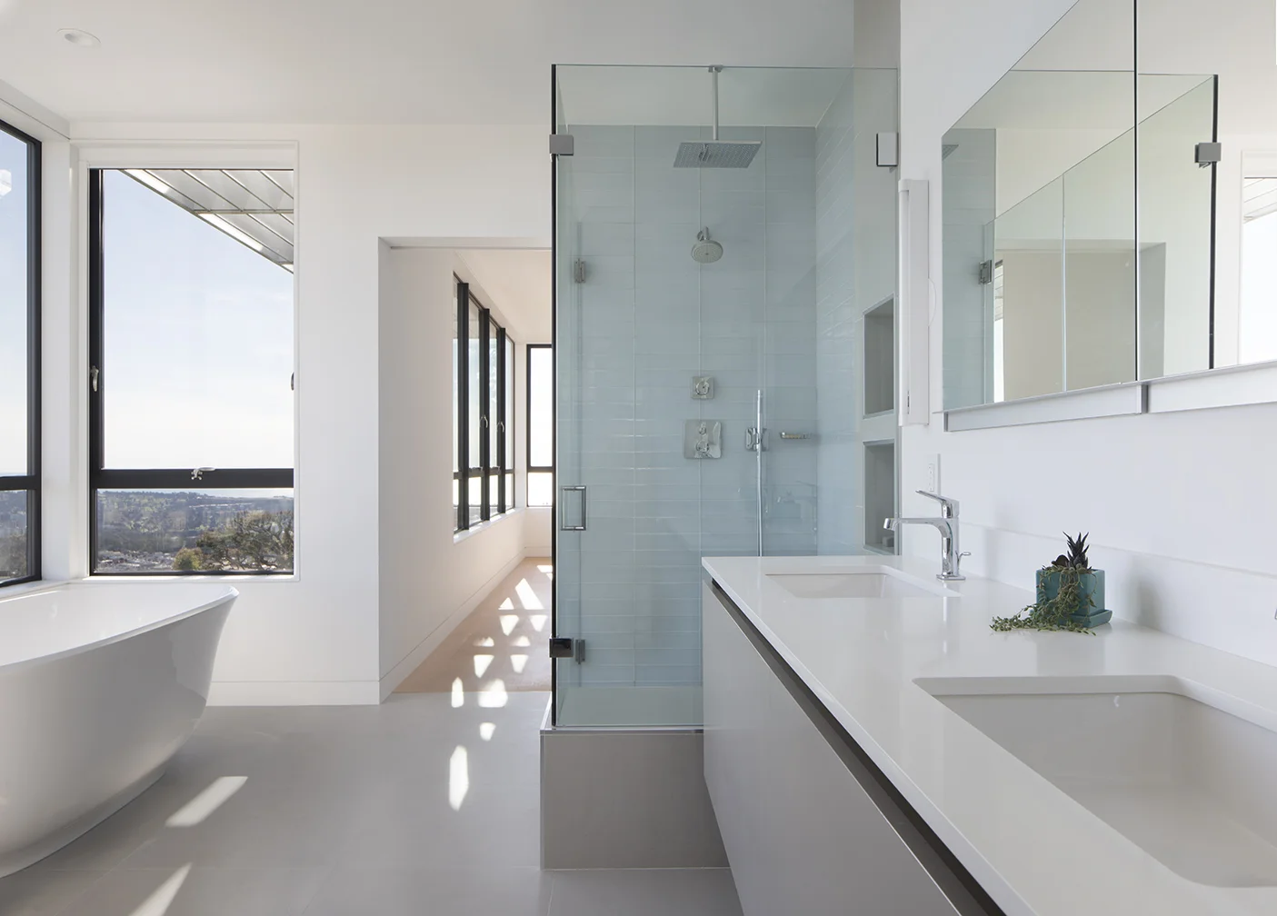 The bathroom continues the white and grey material palette.