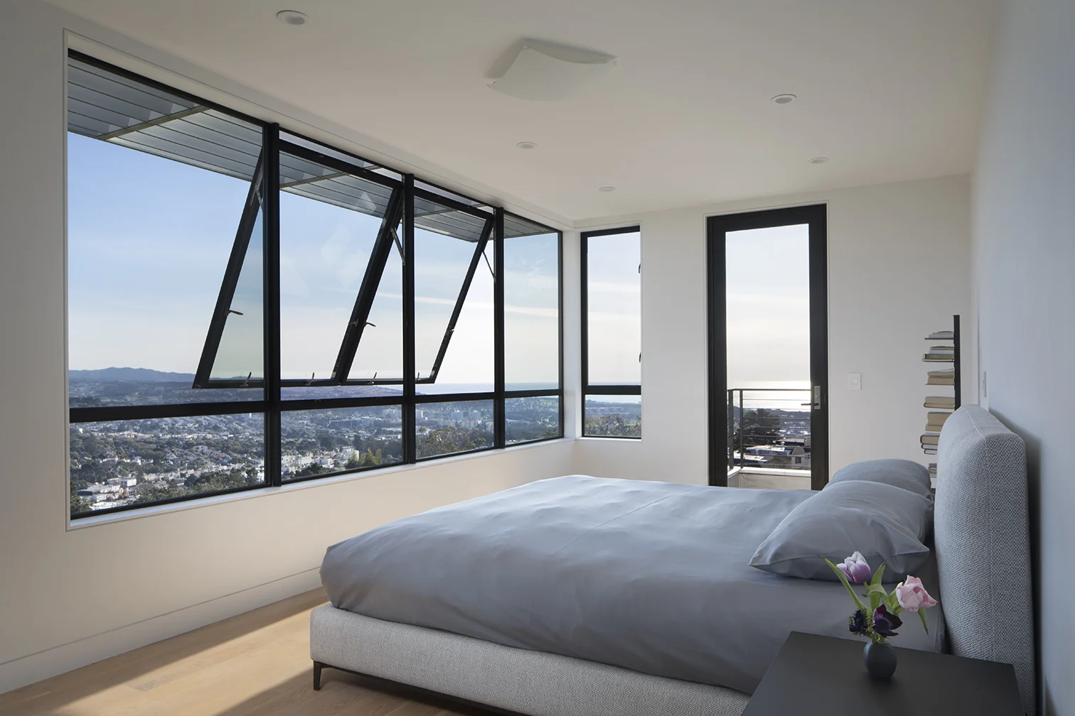 The bedroom overlooks San Francisco and windows open to let in breezes.