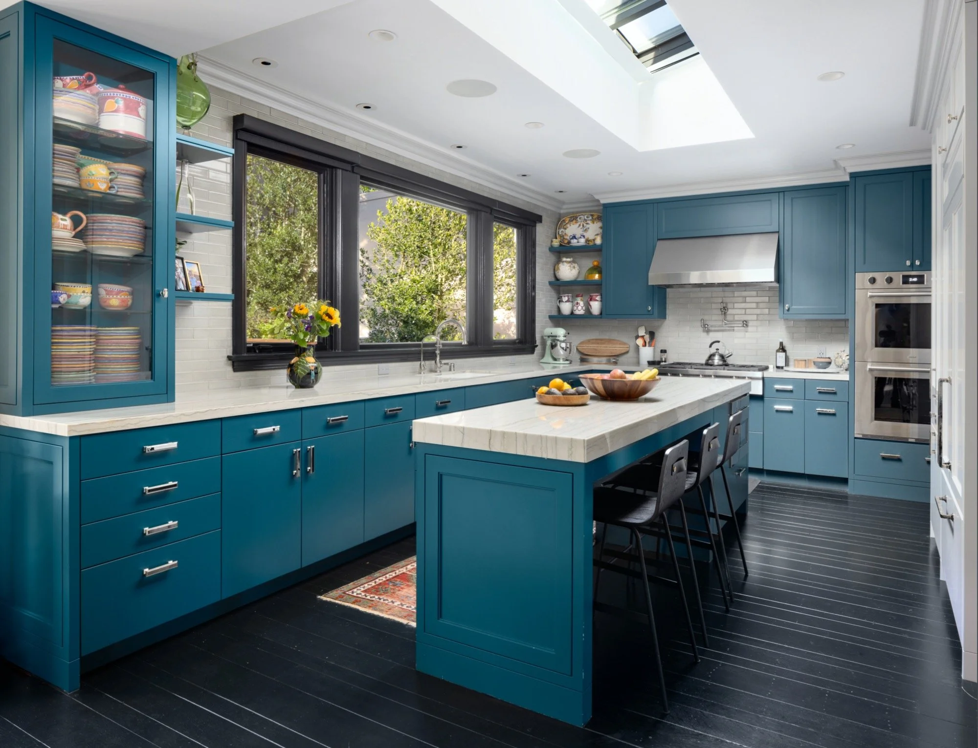  A kitchen with turquoise cabinets and island. 