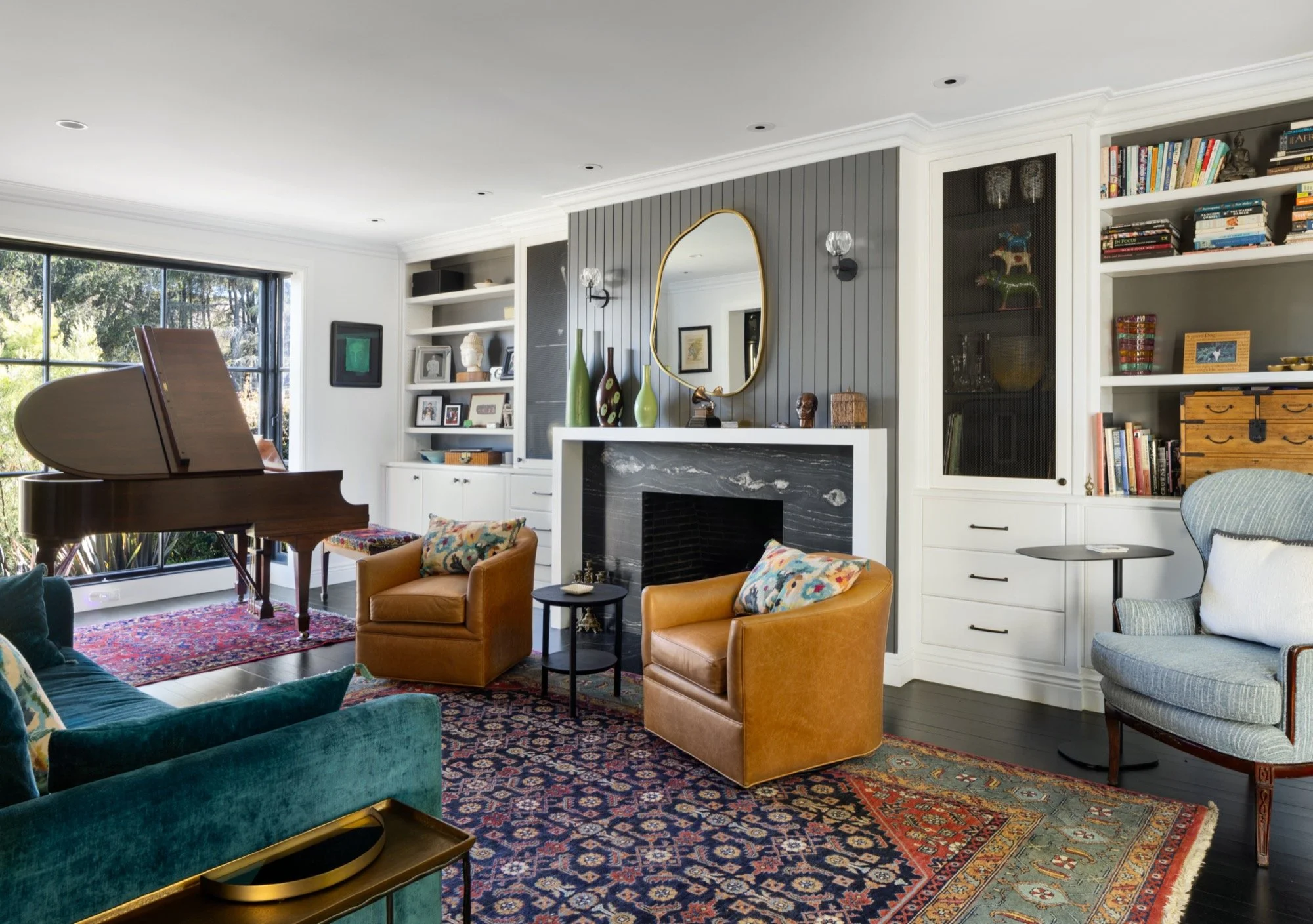  An eclectic living room with club chairs and a baby grand. 