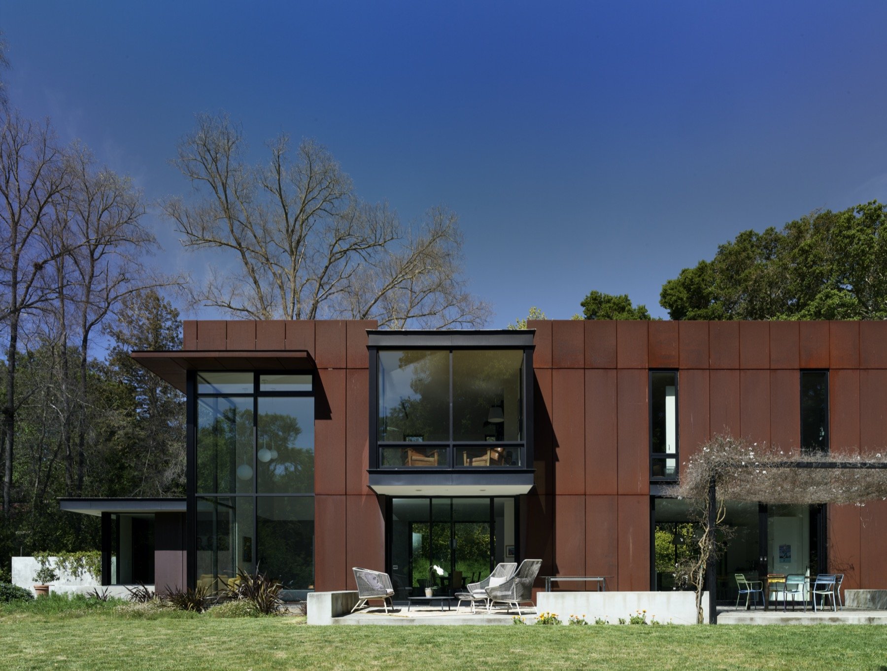  The backyard has a seating area, and an outdoor dining room. 