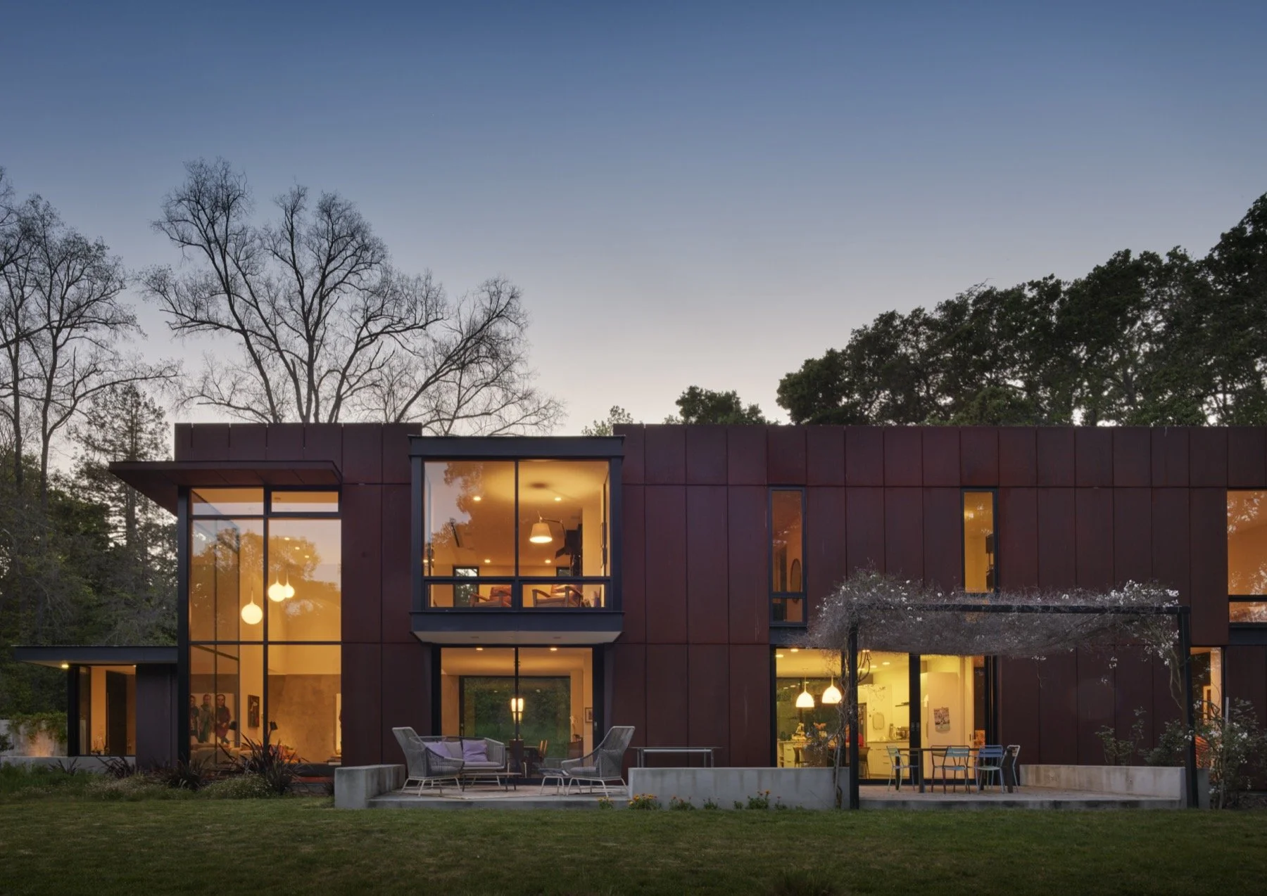  A night view of the back of the house shows the tall windows. 