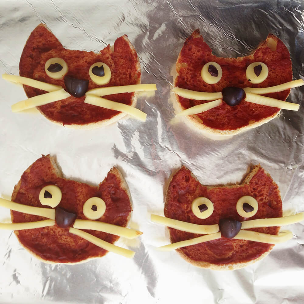 We cut out cat shapes with English muffins to make cat pizzas!