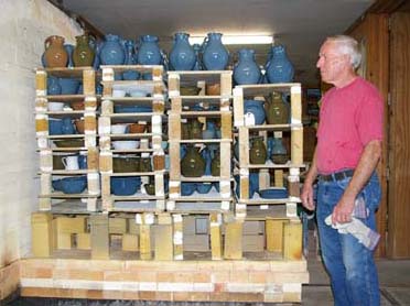 Bobby unloading kiln he has fired.
