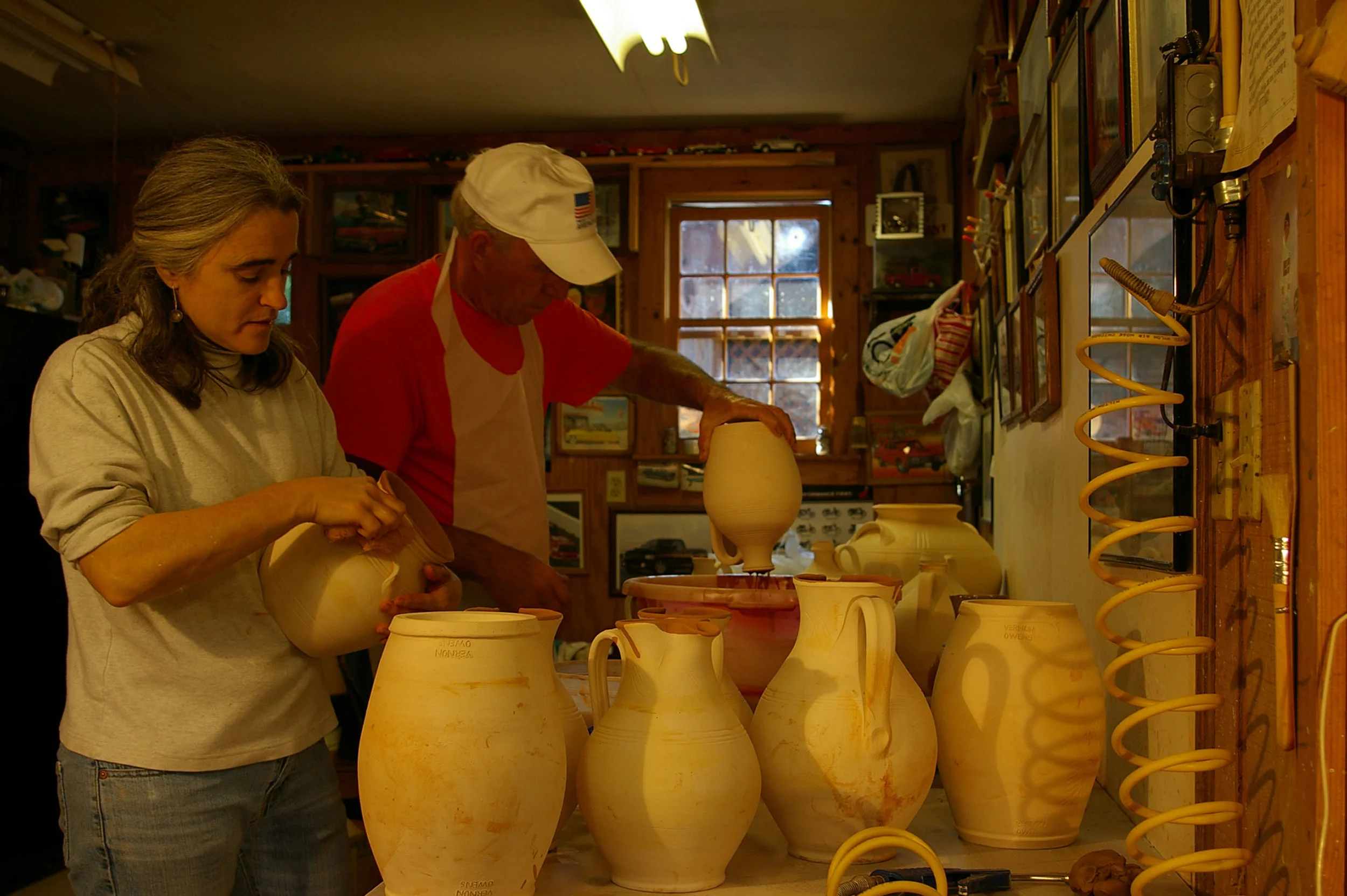 Bobby and Pam working in the glaze room.