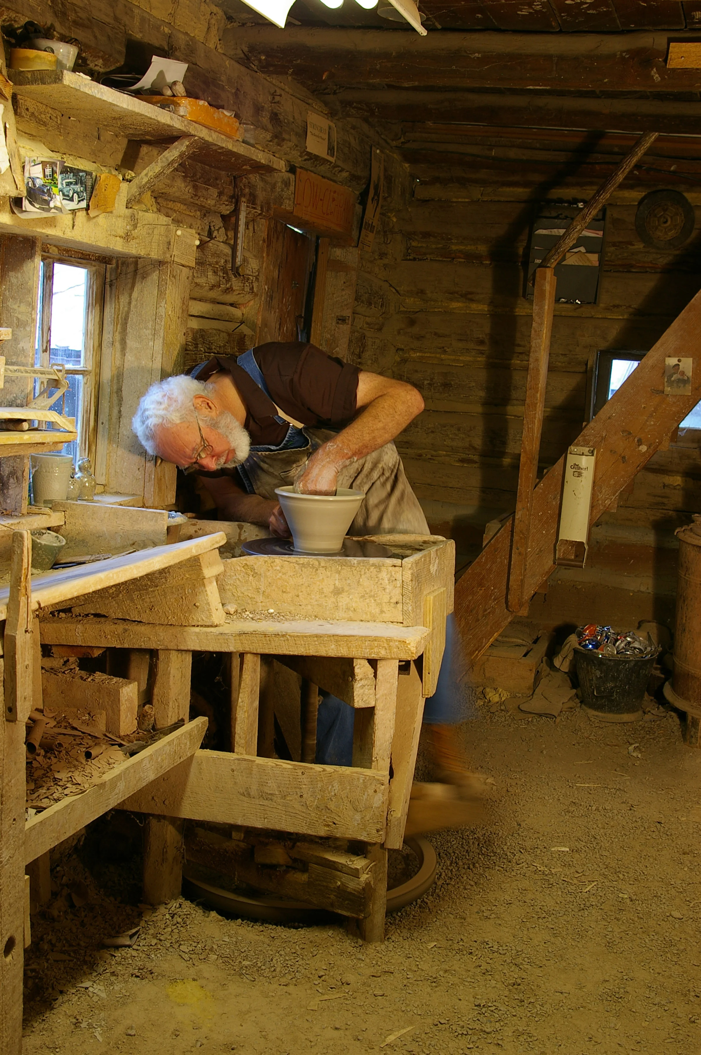 Vernon making a pot on the old kick-wheel.
