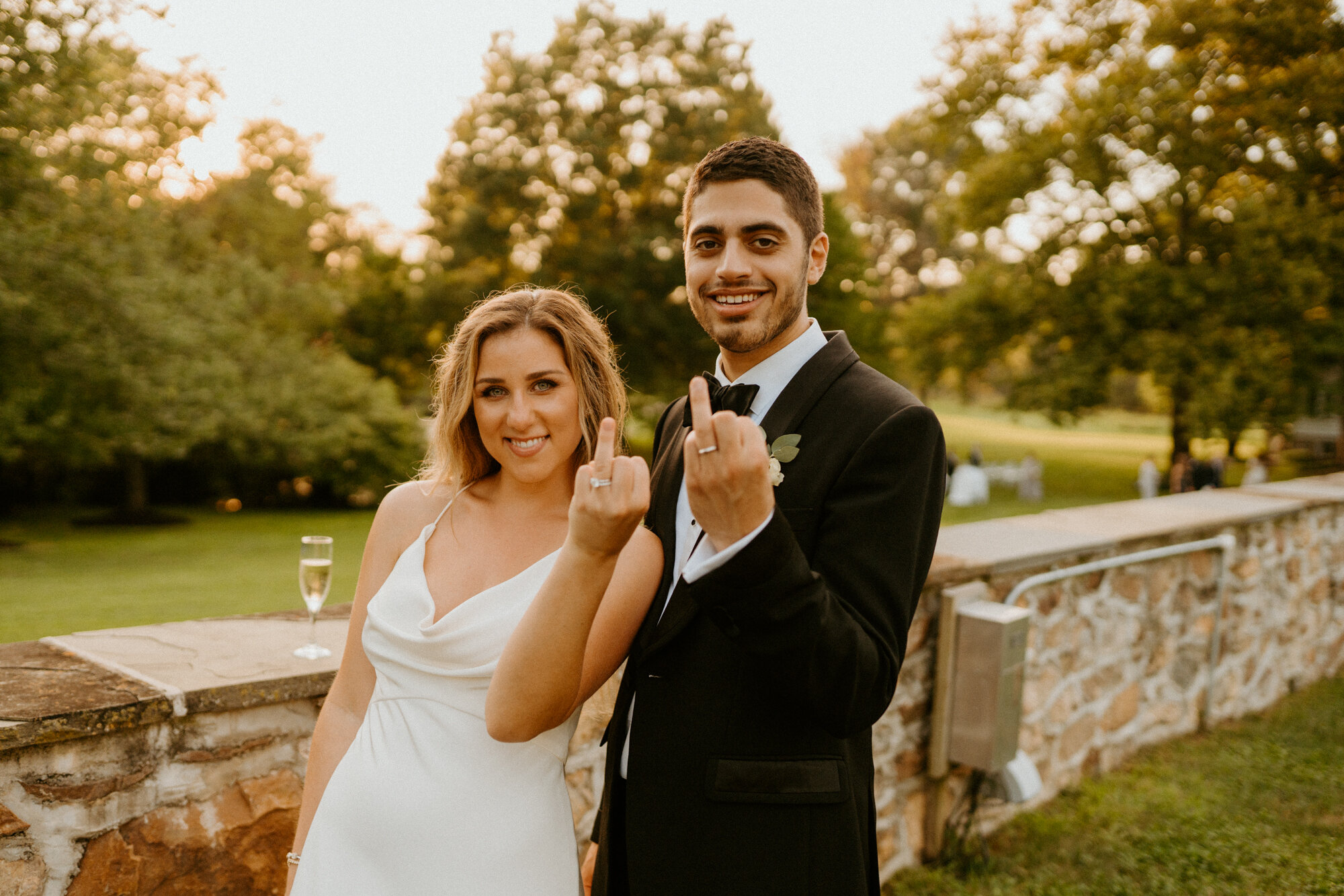 bride and groom holding up ring fingers