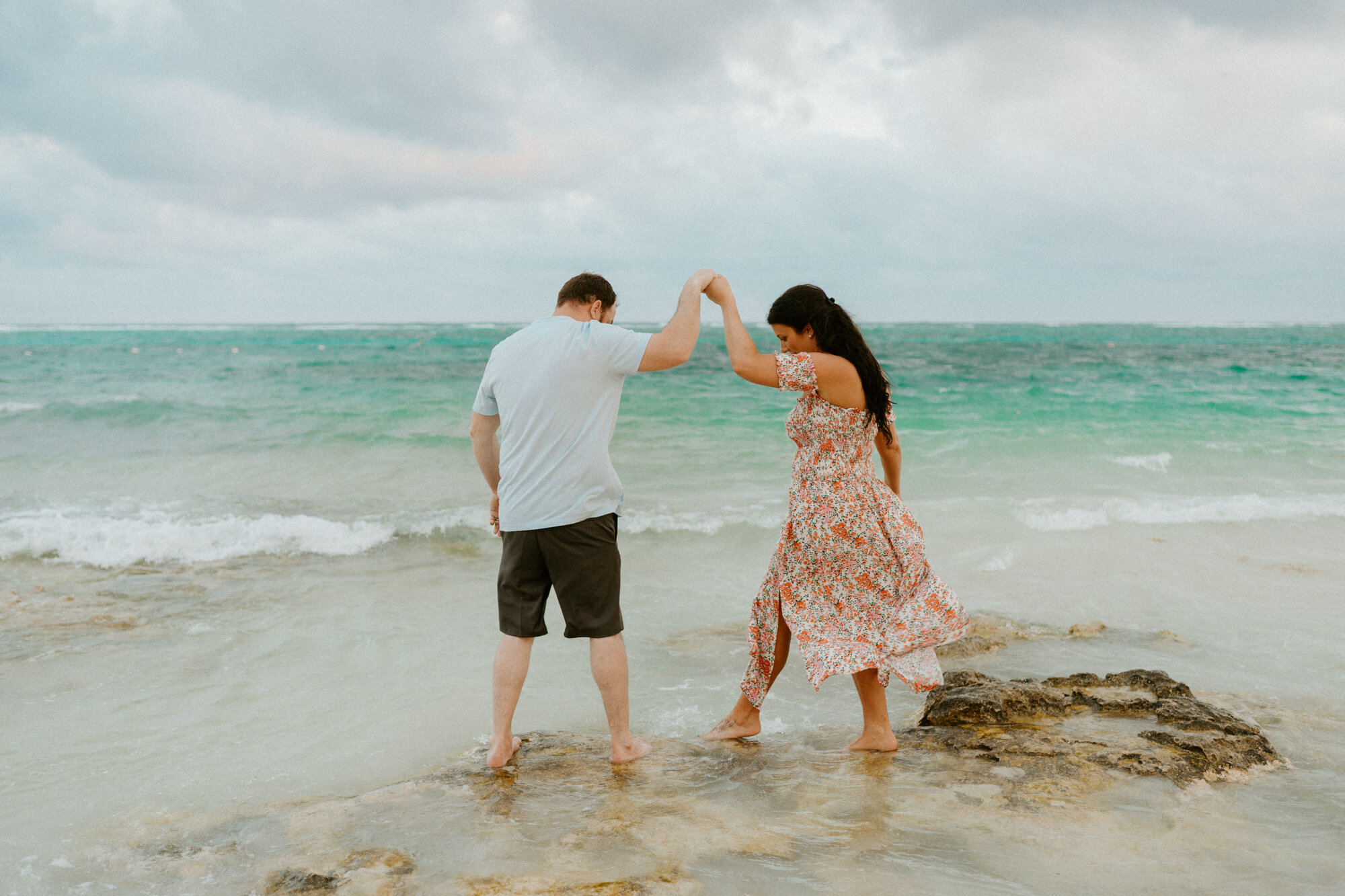 couple holding hands on the beach in riviera maya mexico