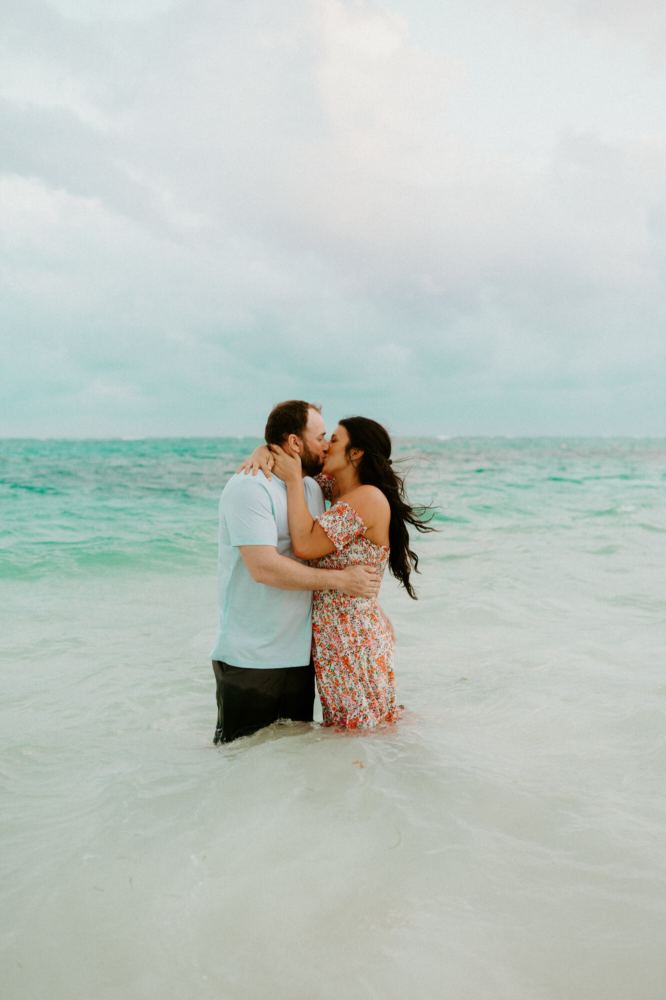 couple kissing in the water in riviera maya mexico