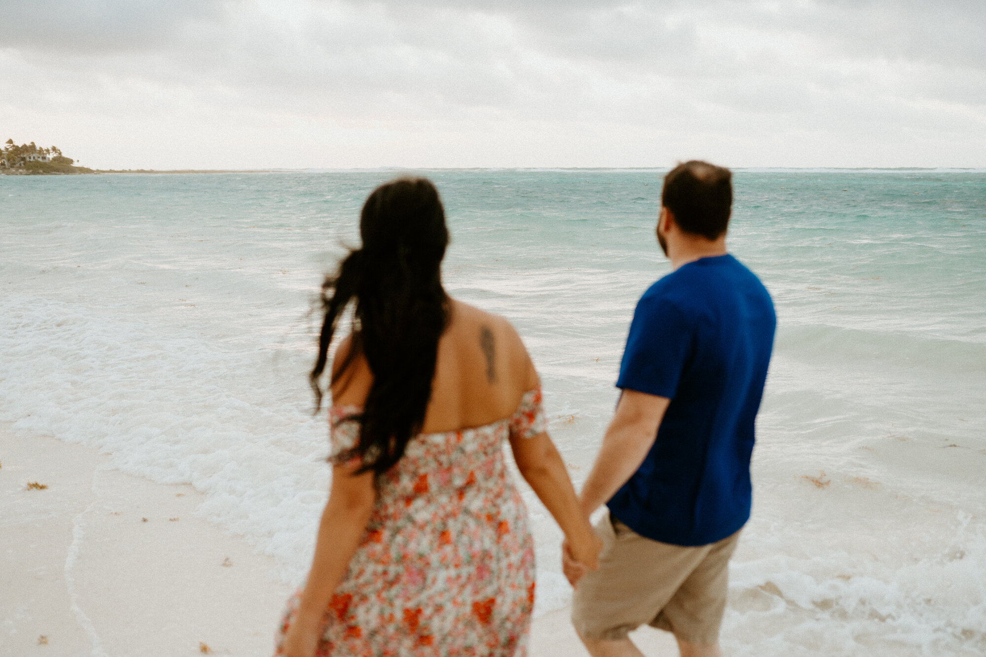 holding hands on the beach in riviera maya mexico