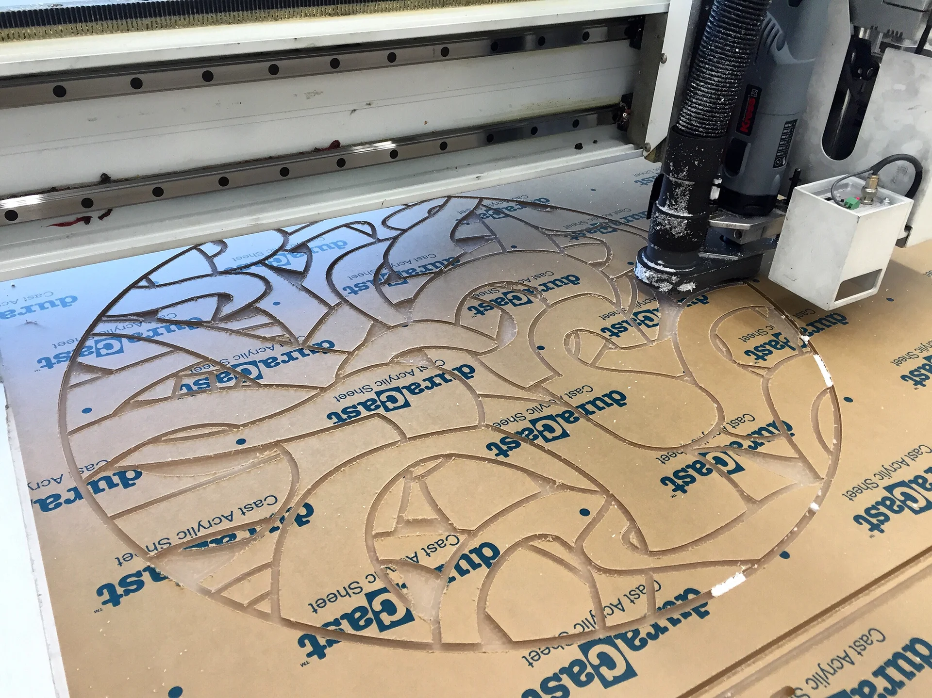 Engraving the mirrored drawing into Plexiglass.