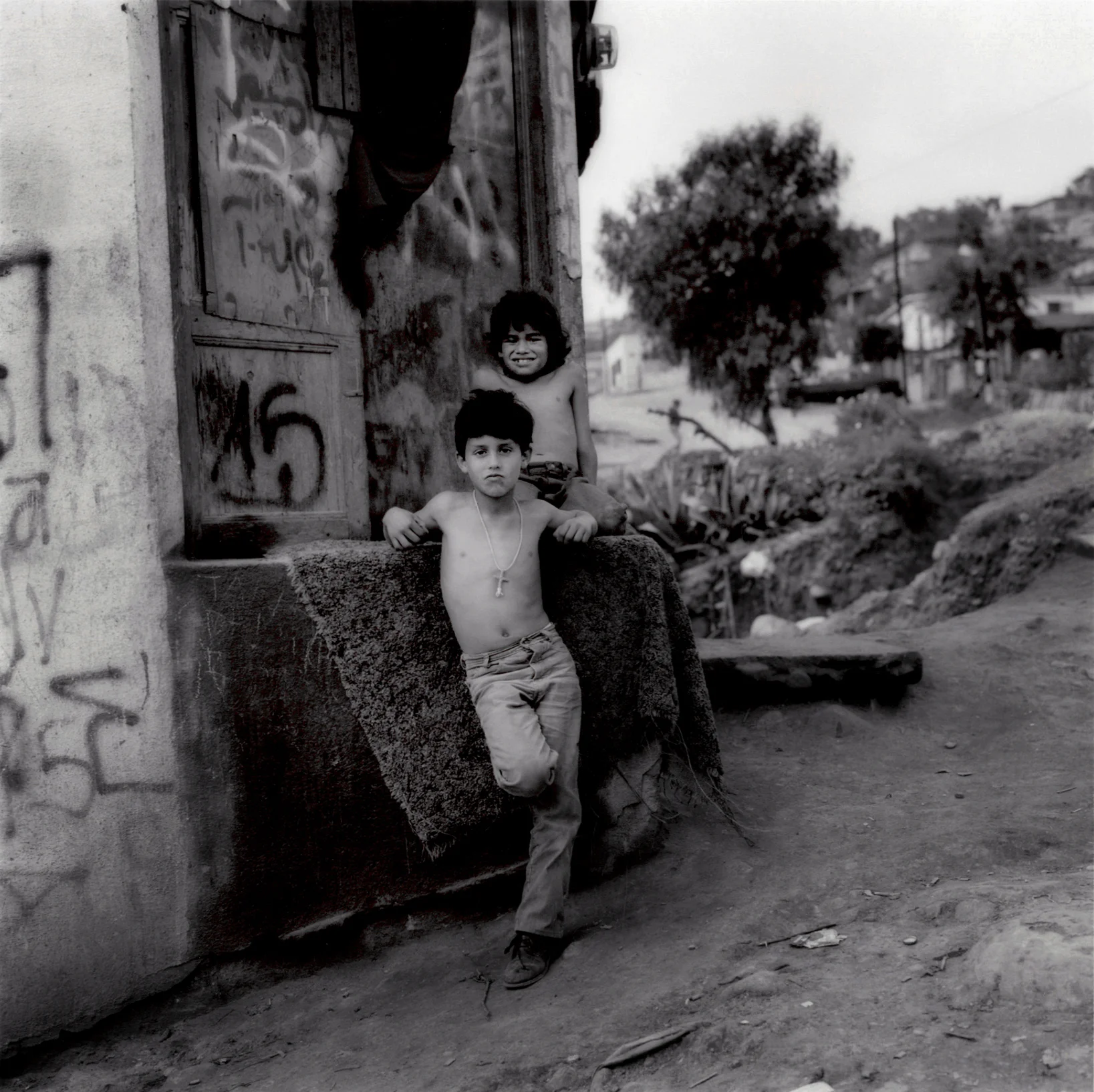 Young boys from Colonia Libertad, Tijuana, just a few hundred meters from the US border fence, Tijuana, Mexico. 2006 There remains deep poverty within Tijuana, although the infrastructure has improved significantly over the past three decades in many parts of the city.
