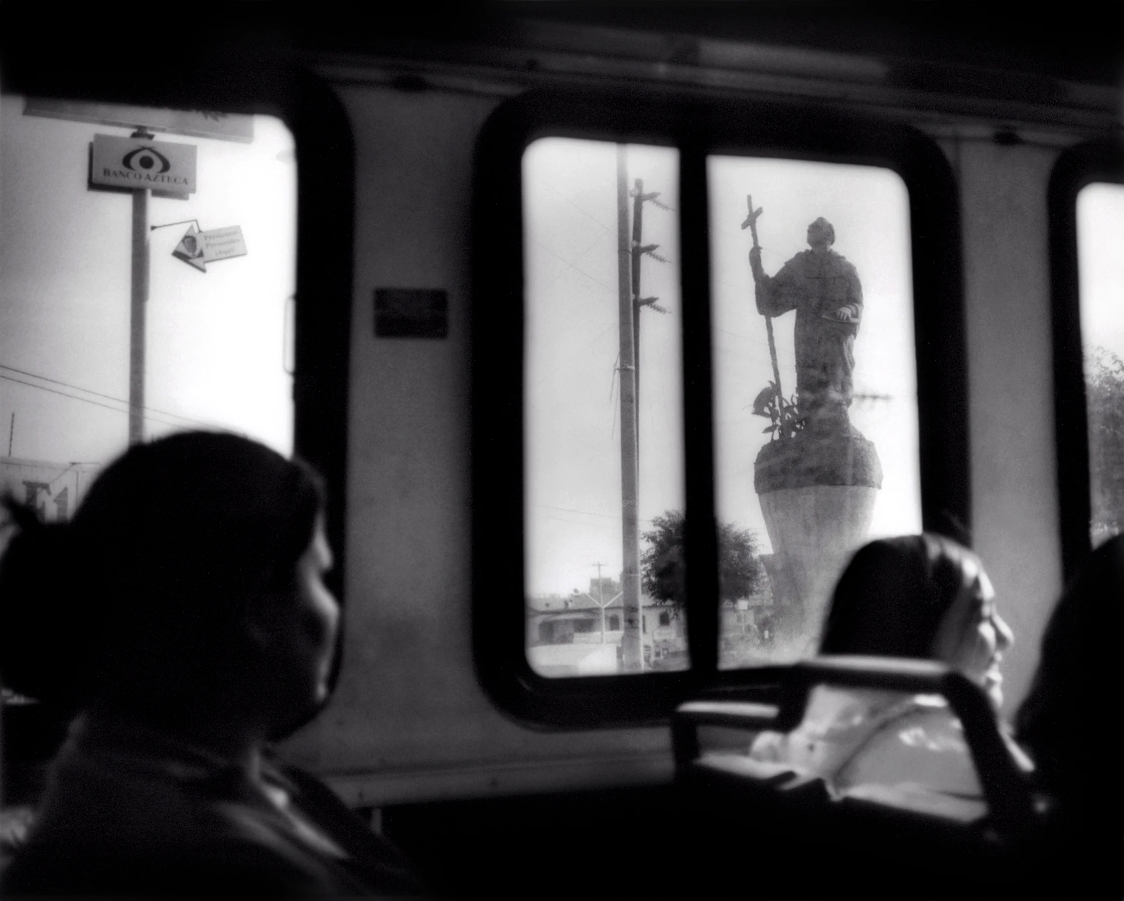 A marble statue of a Catholic saint as seen from a Tijuana city bus, Mexico. Catholicism occupies a central position in Mexican society. 2006
