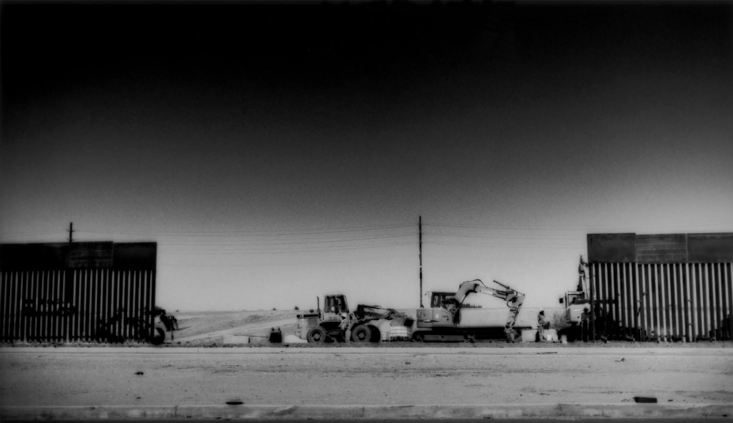 Closing a gap: American workers erect a border fence to further separate Mexicali, Mexico for Calexico on the US side, Baja California, Mexico. The US border fence is known as the "Wall of Shame" (El Muro de Verguenza) south of the border. 2008