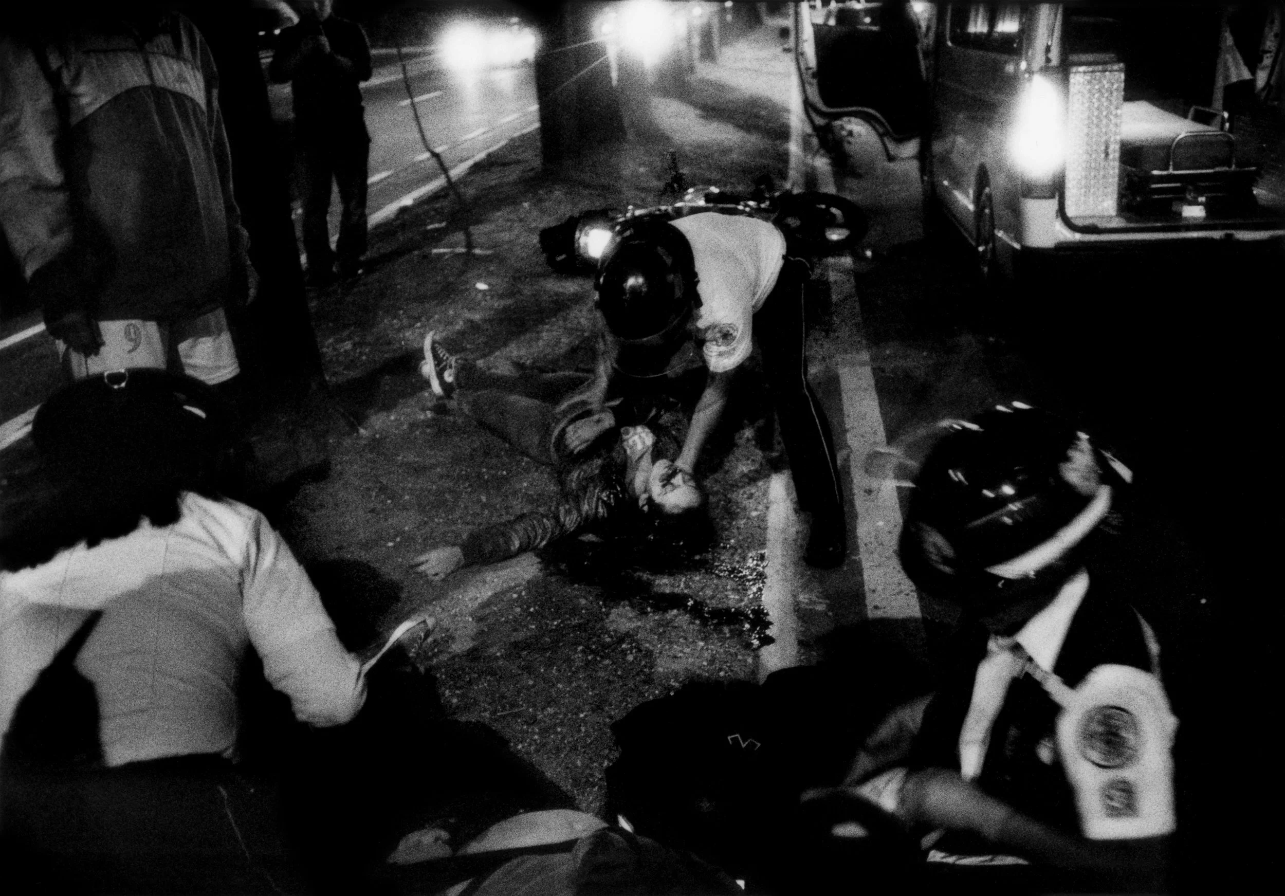 Help comes too late for one teenaged victim of a high-speed motorcycle accident while "bomberos voluntarios" paramedics attend to the other rider who is fighting for her life. Bomberos suspected that drugs or alcohol contributed to the accident in Guatemala City's crime-riddled Zone 7. 2014