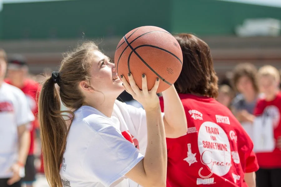 Alex's sister, Sophie Betzhold, takes a shot at the annual Shoot 4 The Stars basketball tournament.