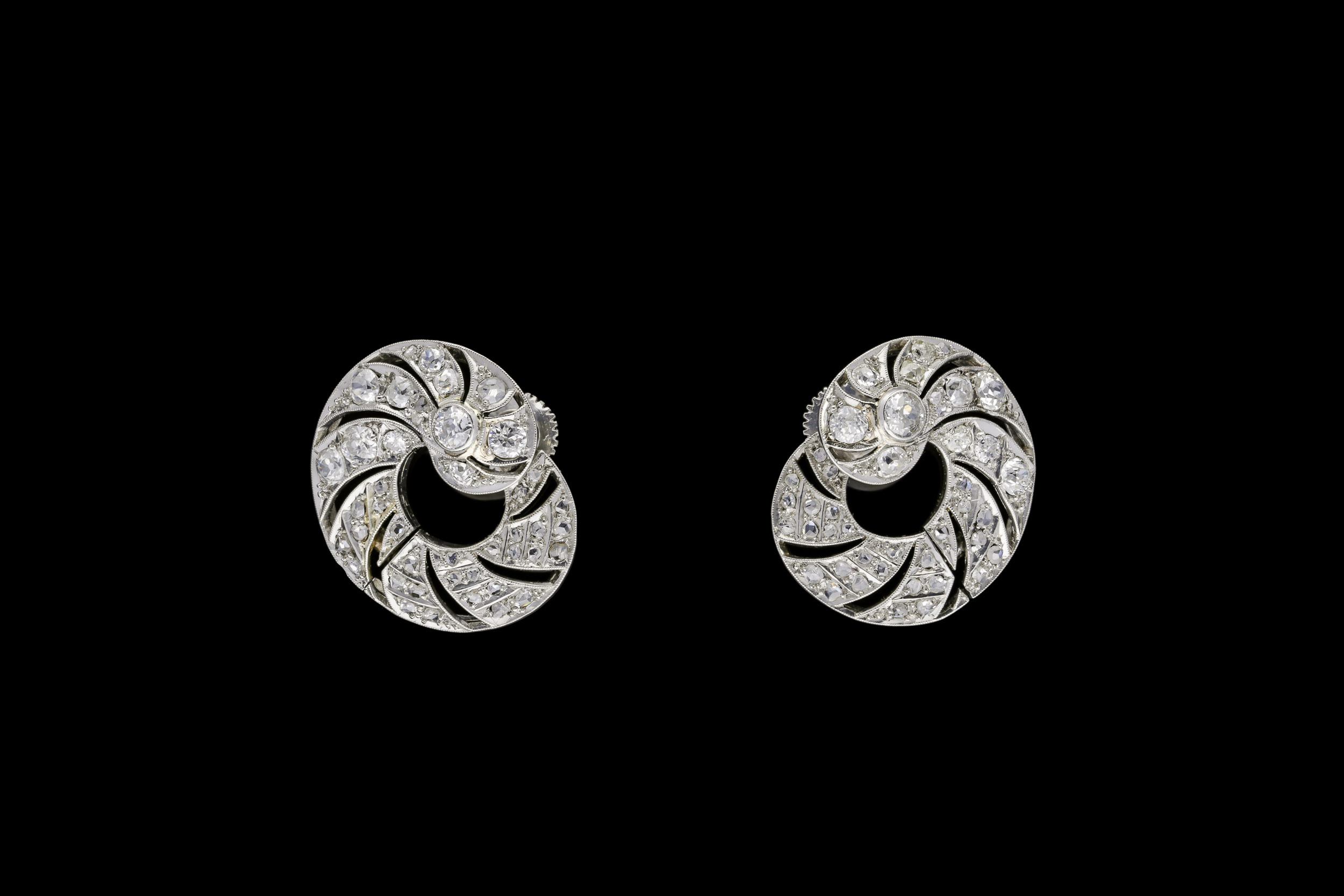 An ingenious pair of late 1930's pierced openwork Art Deco diamond swirl earrings set | £9257