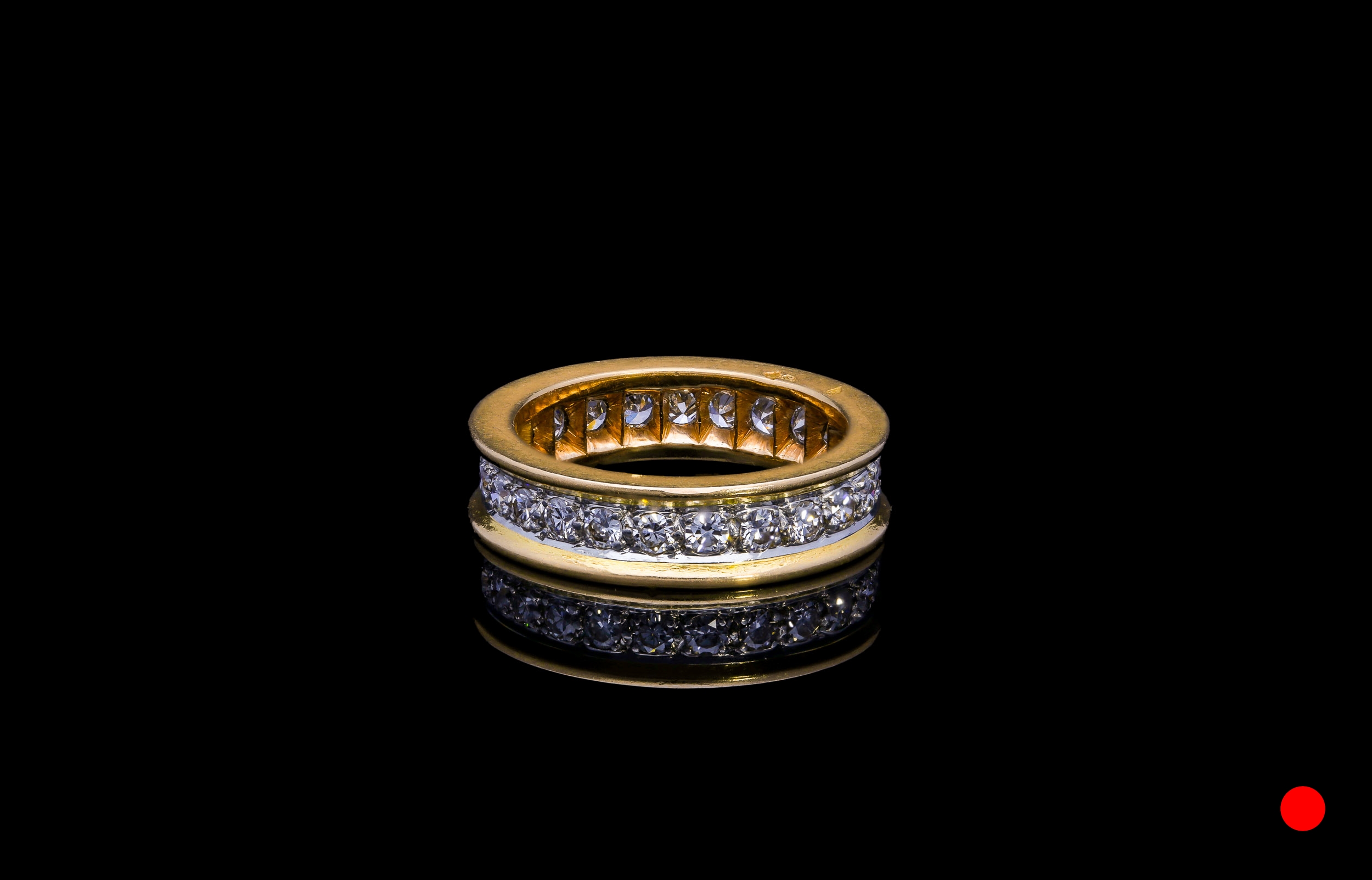 A French 1940's platinum and 18ct rose gold transitional round brilliant cut diamond eternity ring | £3250