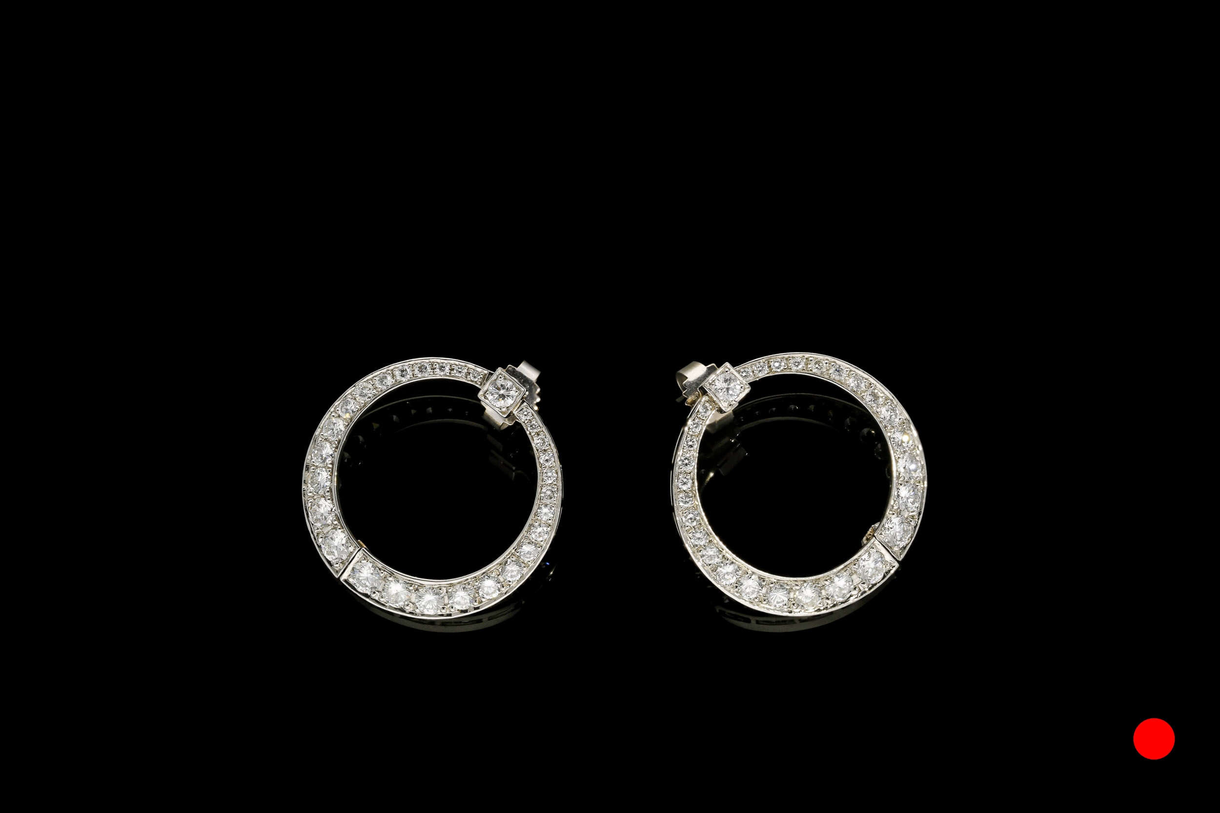 An ingenious pair of Art Deco platinum and diamond hinged wrap around hoop earrings | £7450