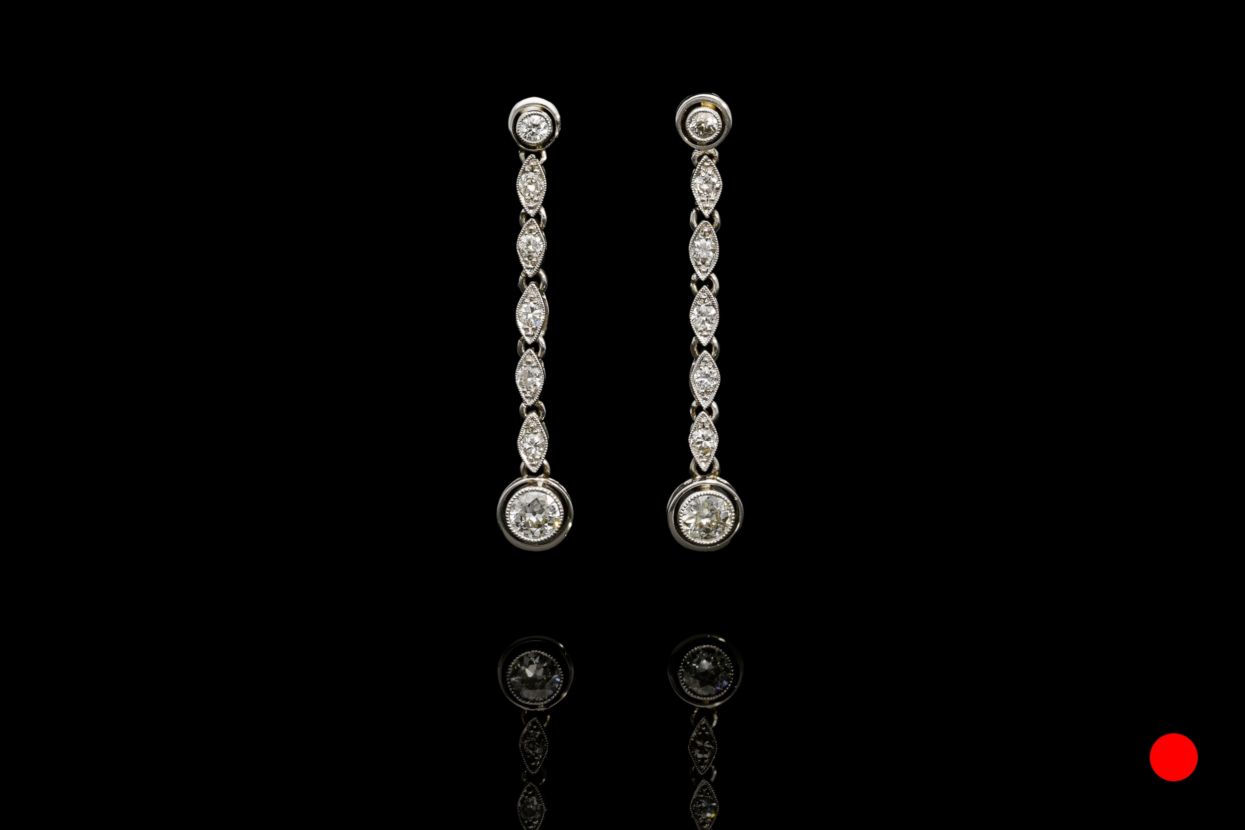 A stylish pair of 1950's transitional round brilliant cut diamond drop earrings set | £6450