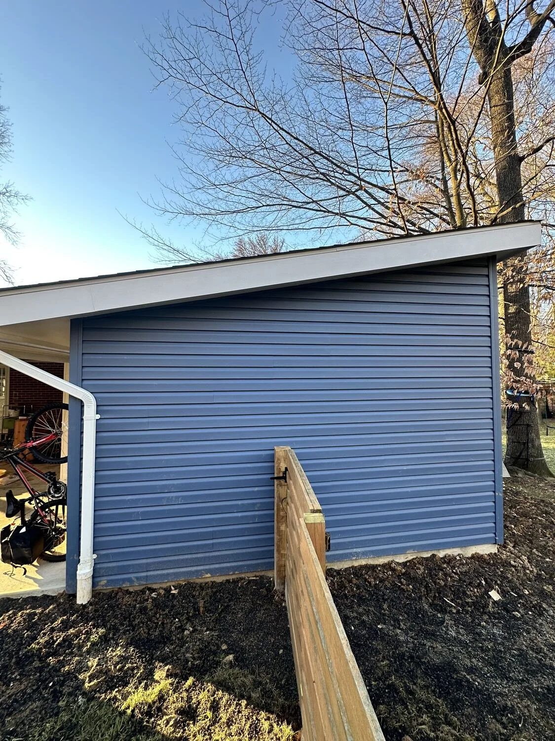 Workshop addition with matching siding and roofline, Annandale