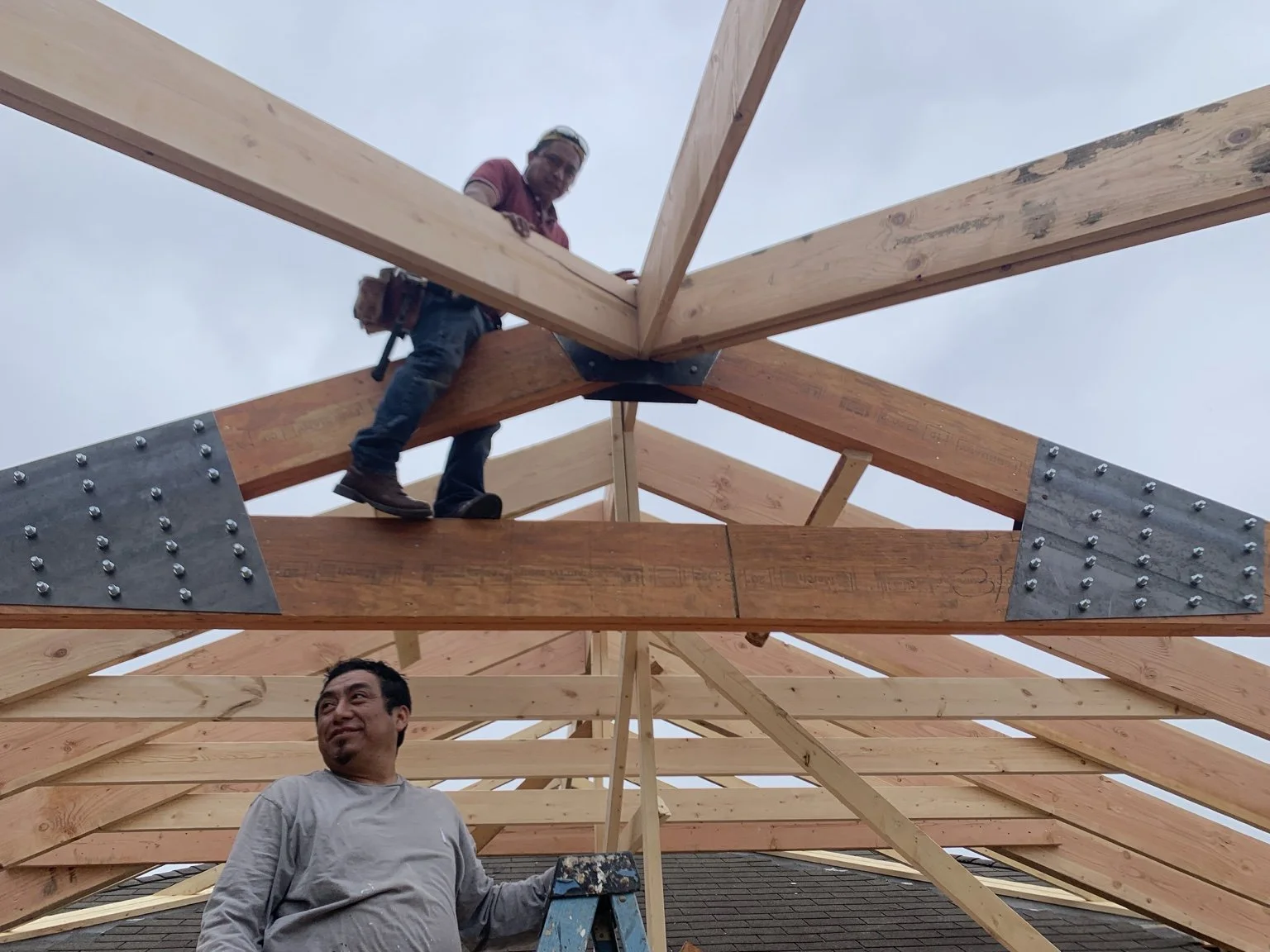 Engineered roof framing and steel connection plates during construction of the garage addition.