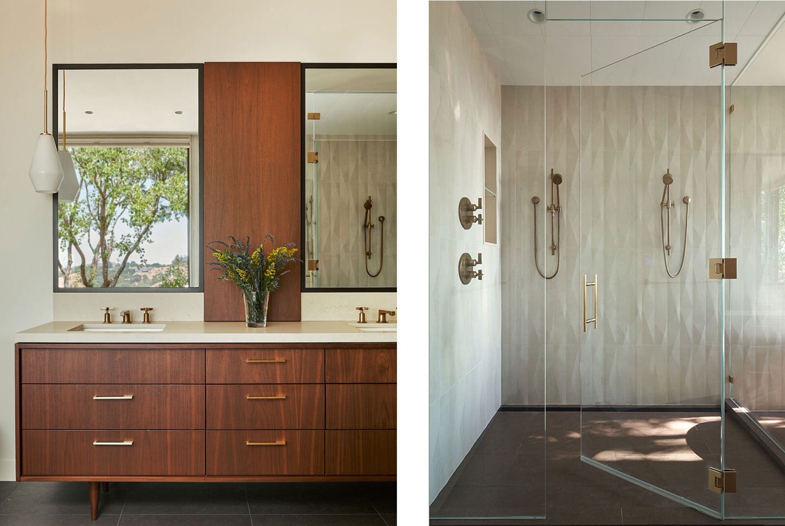 Mid-century-modern primary bath with walnut vanity and medicine cabinet, with under-mounted double sinks with brass fixtures and two pendant lights on both sides, and frameless enclosed shower with geometric tile and brass fixtures