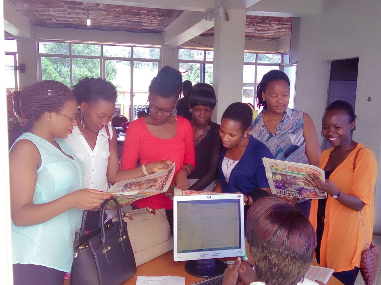Too-rom with her UCU classroom group visiting a local Ugandan newspaper. 