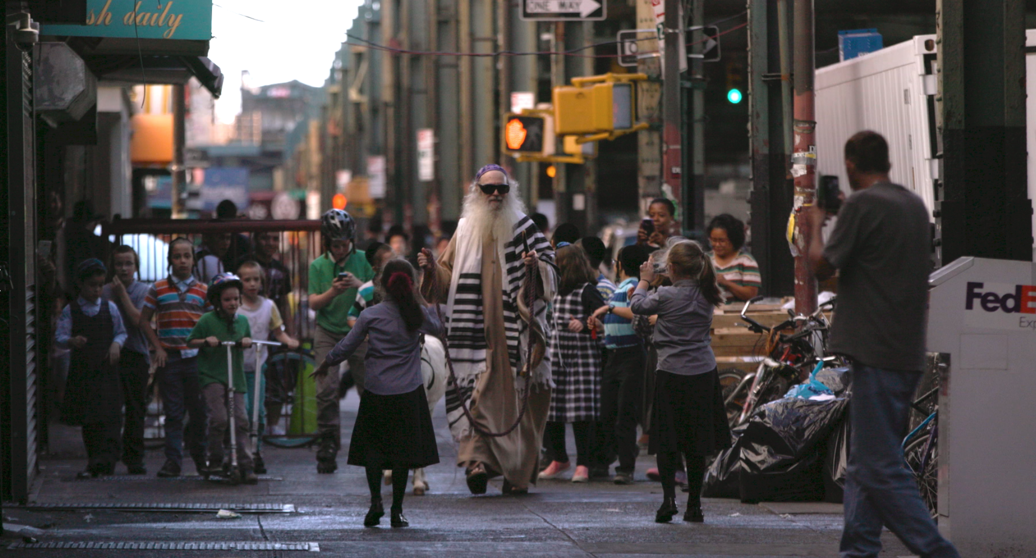 Dennis Gronam, dressed as the Messiah, strolls through Brooklyn guiding a white donkey | Photo courtesy of Messiahsez Facebook