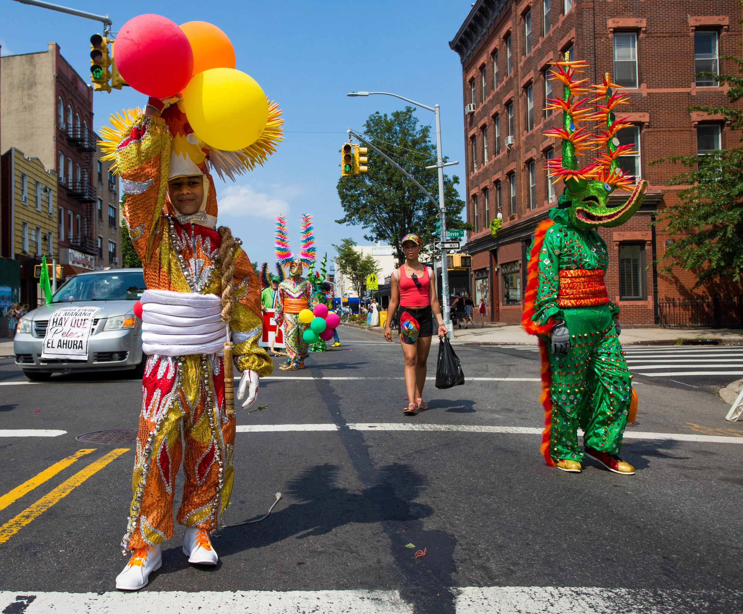 Young and older boys dressed in Carnival costumes and wielding boar whips at the 18th annual Williamsburg Dominican Parade, on Sunday, Aug 26, in New York. Photo: Wes Parnell