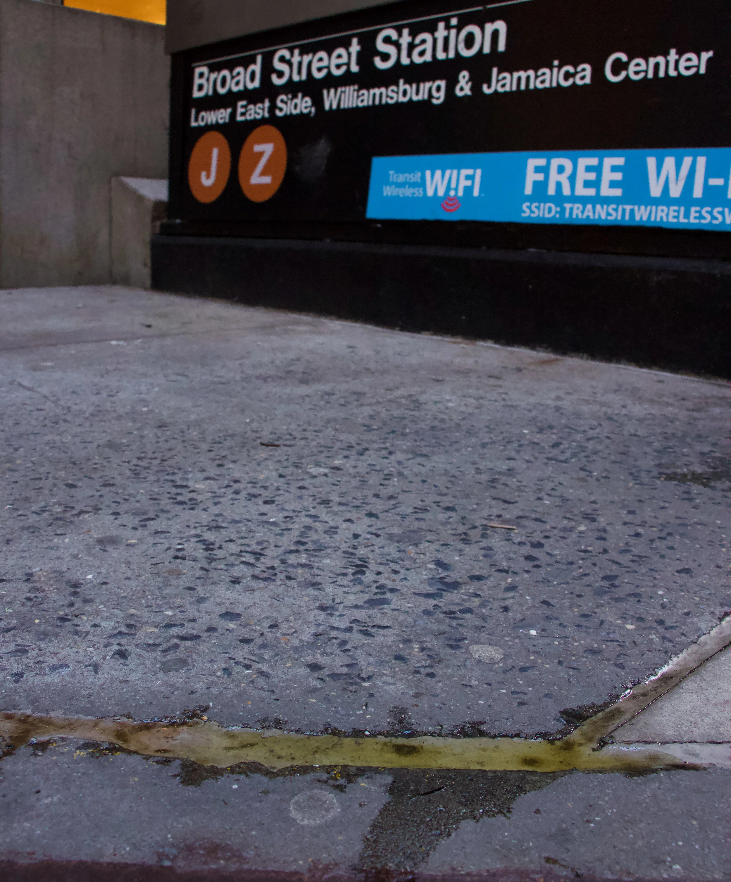 A yellow-liquid substance lies in the crevices outside the J/Z subway station at Broad Street. || Photo credit to Gabriela Kressley.
