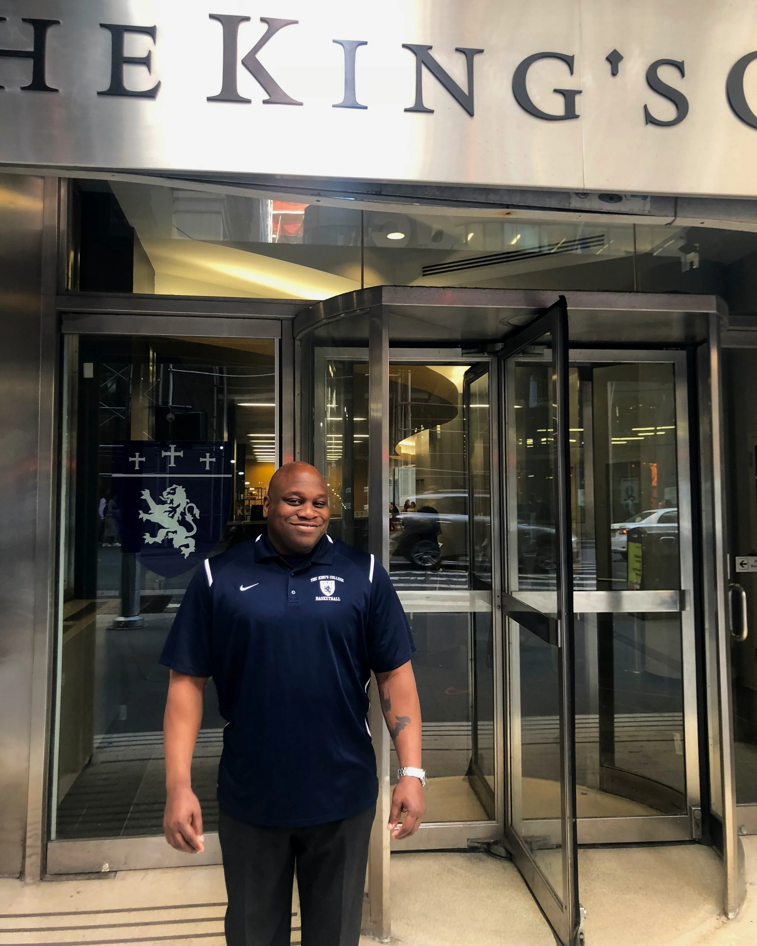 Thomas standing outside The King’s College in the morning before the school opens. || Photo Credit to Njeri McPherson