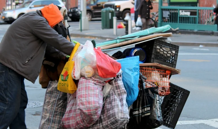 Homeless man with shopping cart in New York City. || Photo credit to Tona Leggio