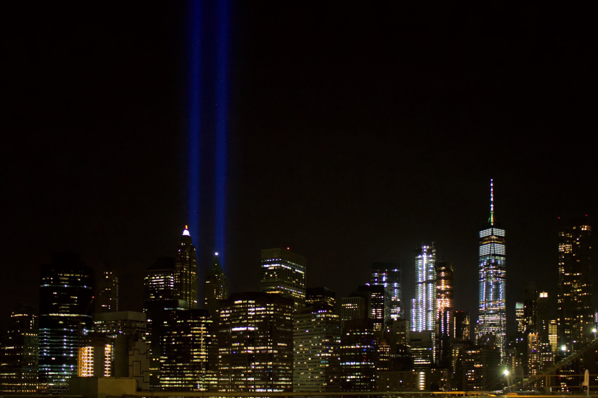The Tribute in Light is an art installation of 88 searchlights placed six blocks south of the World Trade Center on top of the Battery Parking Garage in New York City to create two vertical columns of light to represent the Twin Towers in remembrance of the September 11 attacks. || Photo credit to Gabriela Kressley