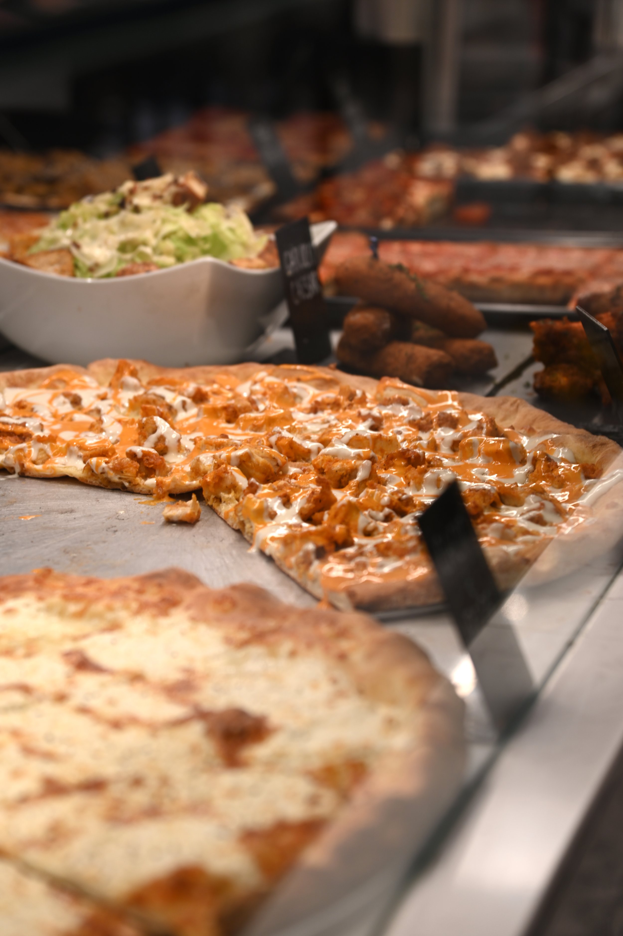  Siena Pizza and Cannoli has many different pizza pie flavors, featuring their Buffalo Chicken Pizza, a bestseller at the restaurant in the Financial District of Manhattan, NY on Oct. 12, 2021. (Alyse Messmer/The King's College) 