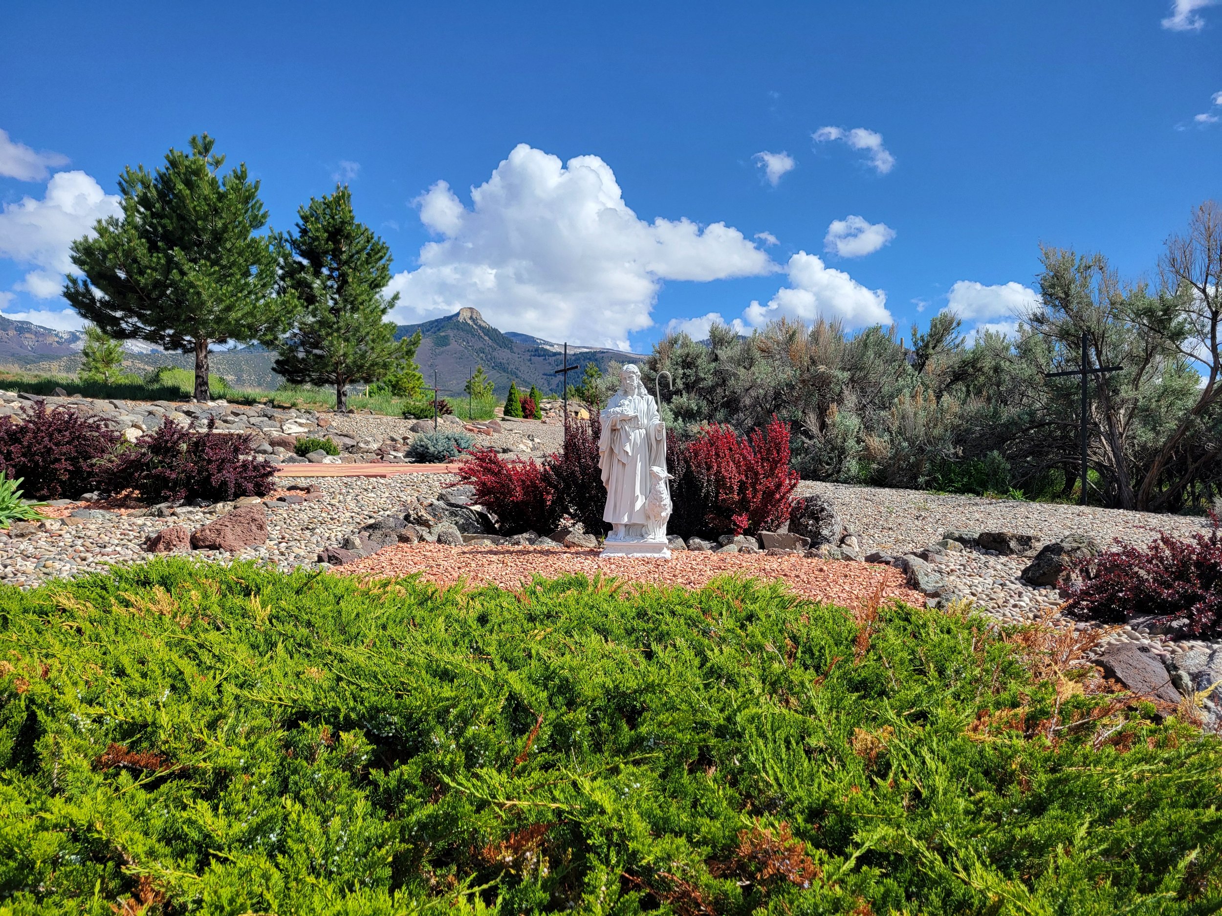 Meditation area with white statue of Jesus as Shepherd