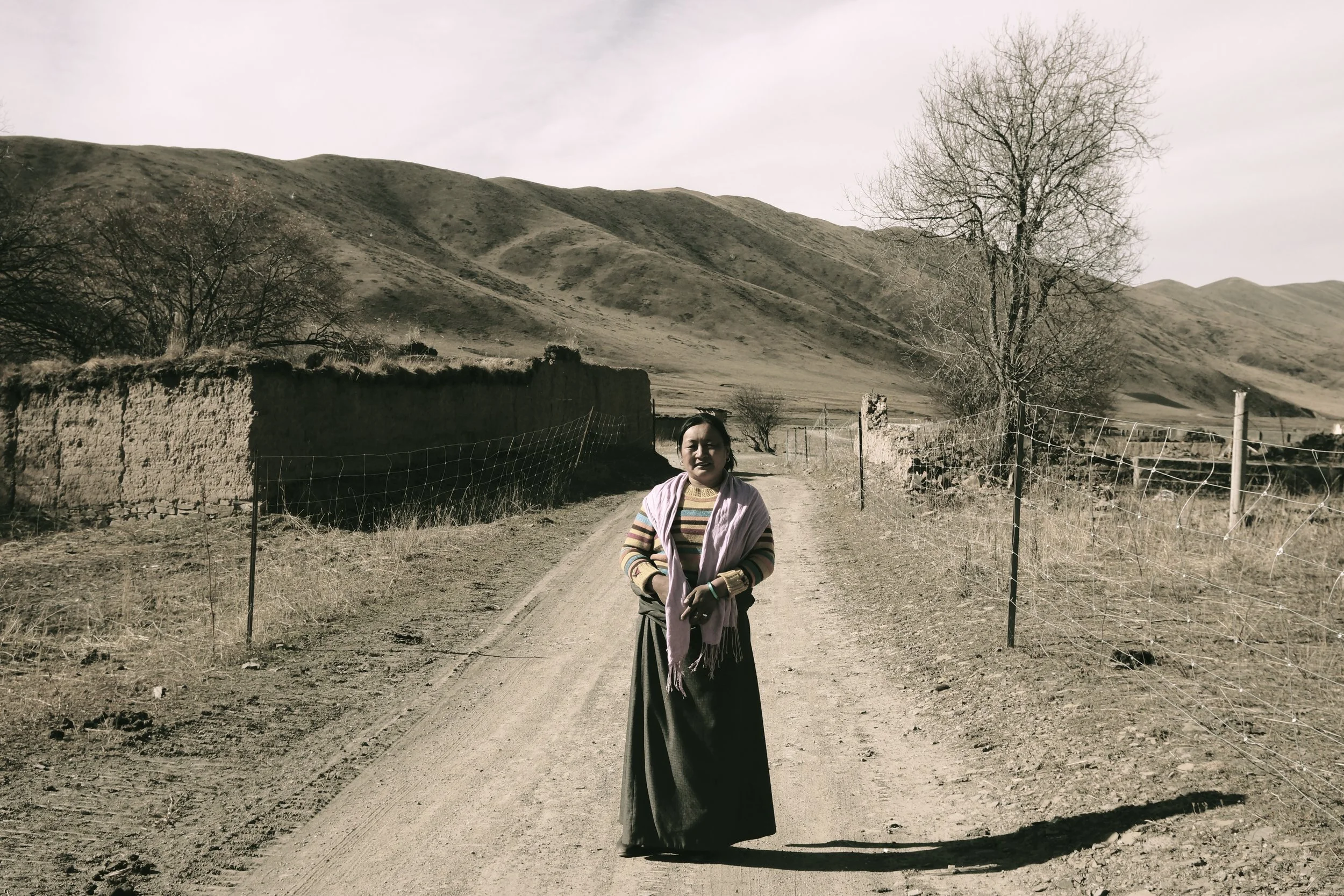Tsezen in front of her childhood village, bulldozed by the Chinese