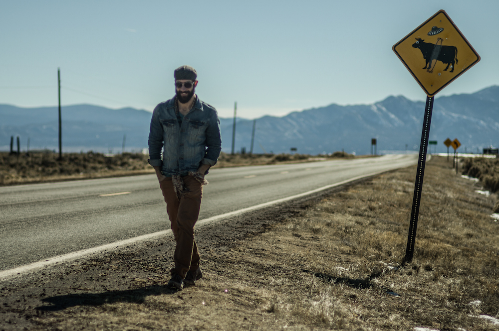 Mike Wojniak walking down a Colorado roadside.