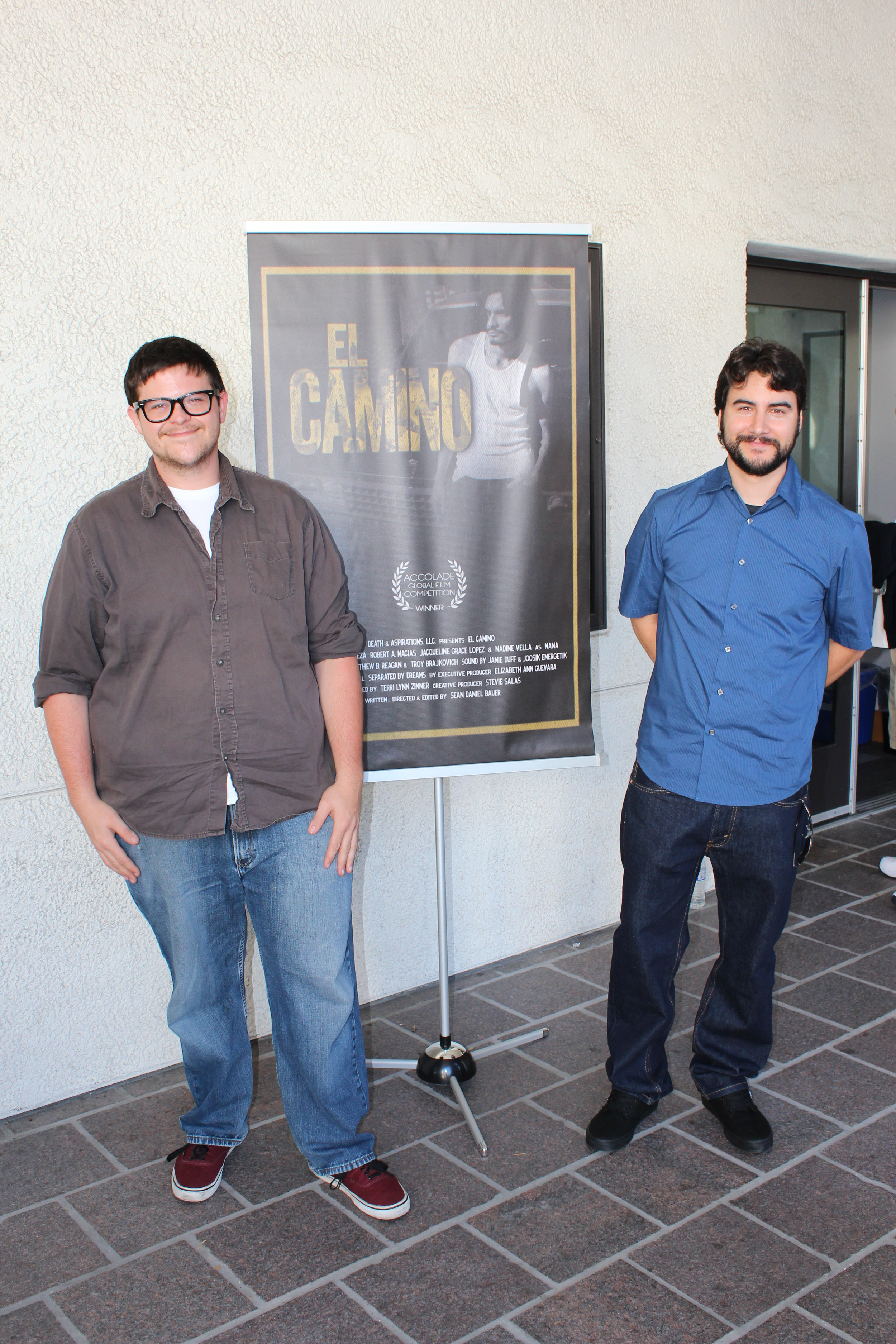 Alec Moore and Sean Daniel Bauer in front of the official El Camino poster.