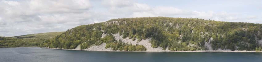 The tall cliffs of Prospect Point peek out atop the West Bluff of Devils Lake State Park.