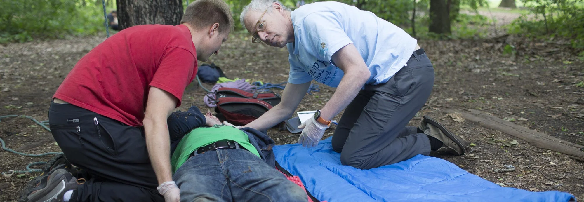 Two students care for a patient in a wilderness medicine drill at the MacKenzie Center during our 5-Day Wilderness First Responder course taught by Wilderness Medical Associates .